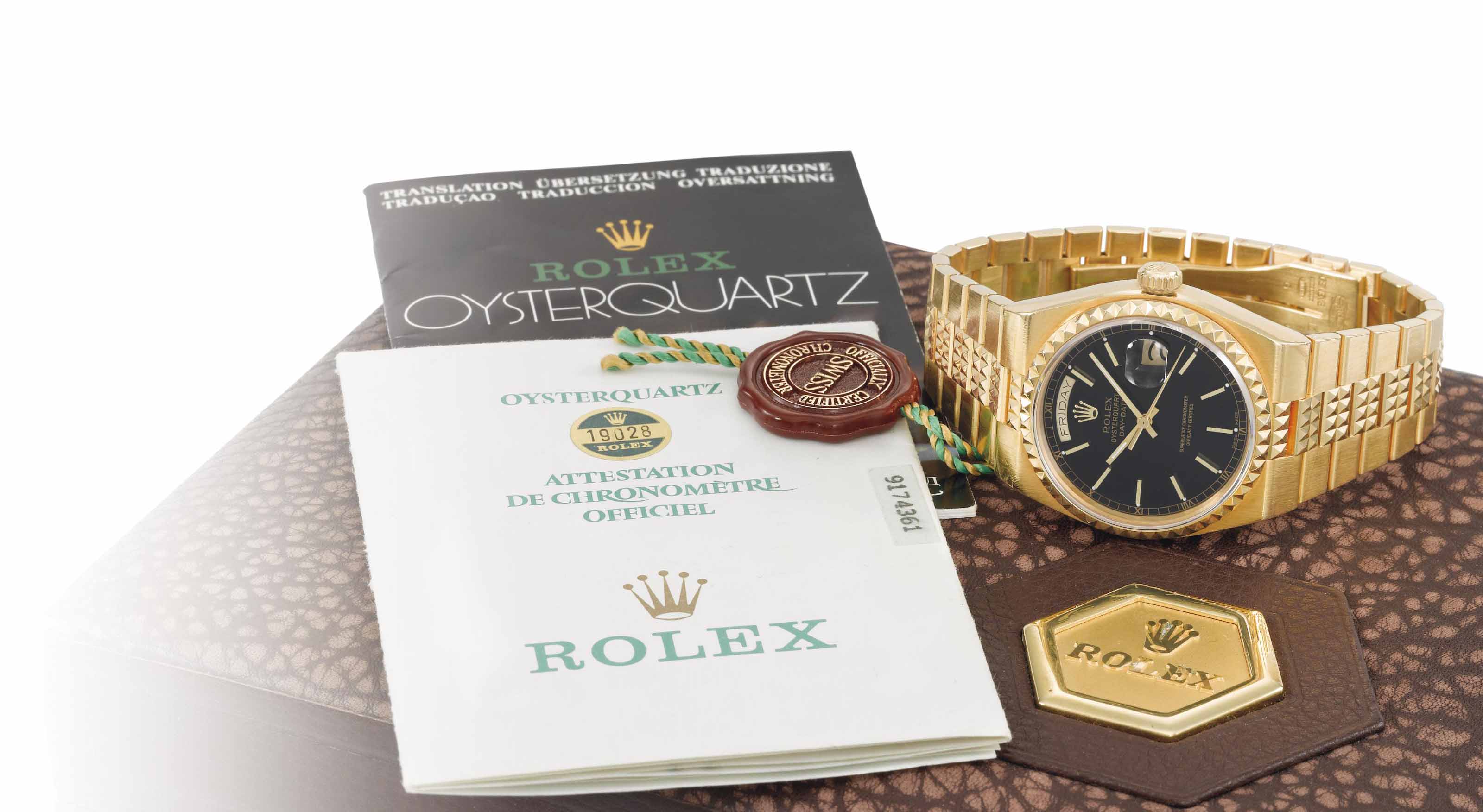 Rolex. A rare, heavy and impressive 18K gold quartz wristwatch with day,  date, black dial, bracelet, original guarantee and box