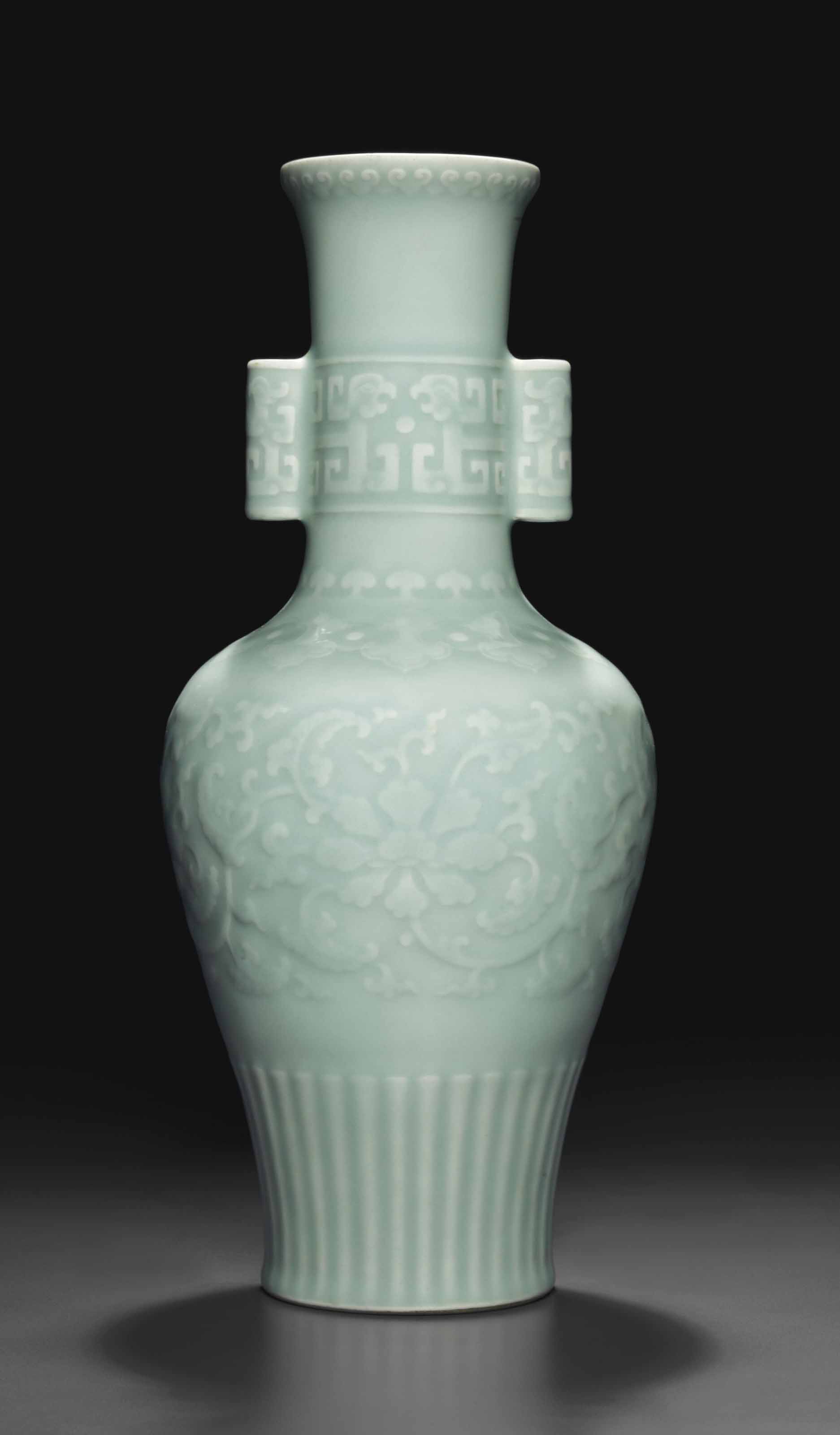 A VERY RARE CELADONGLAZED RELIEFDECORATED BALUSTER VASE , QIANLONG SEAL MARK IN UNDERGLAZE