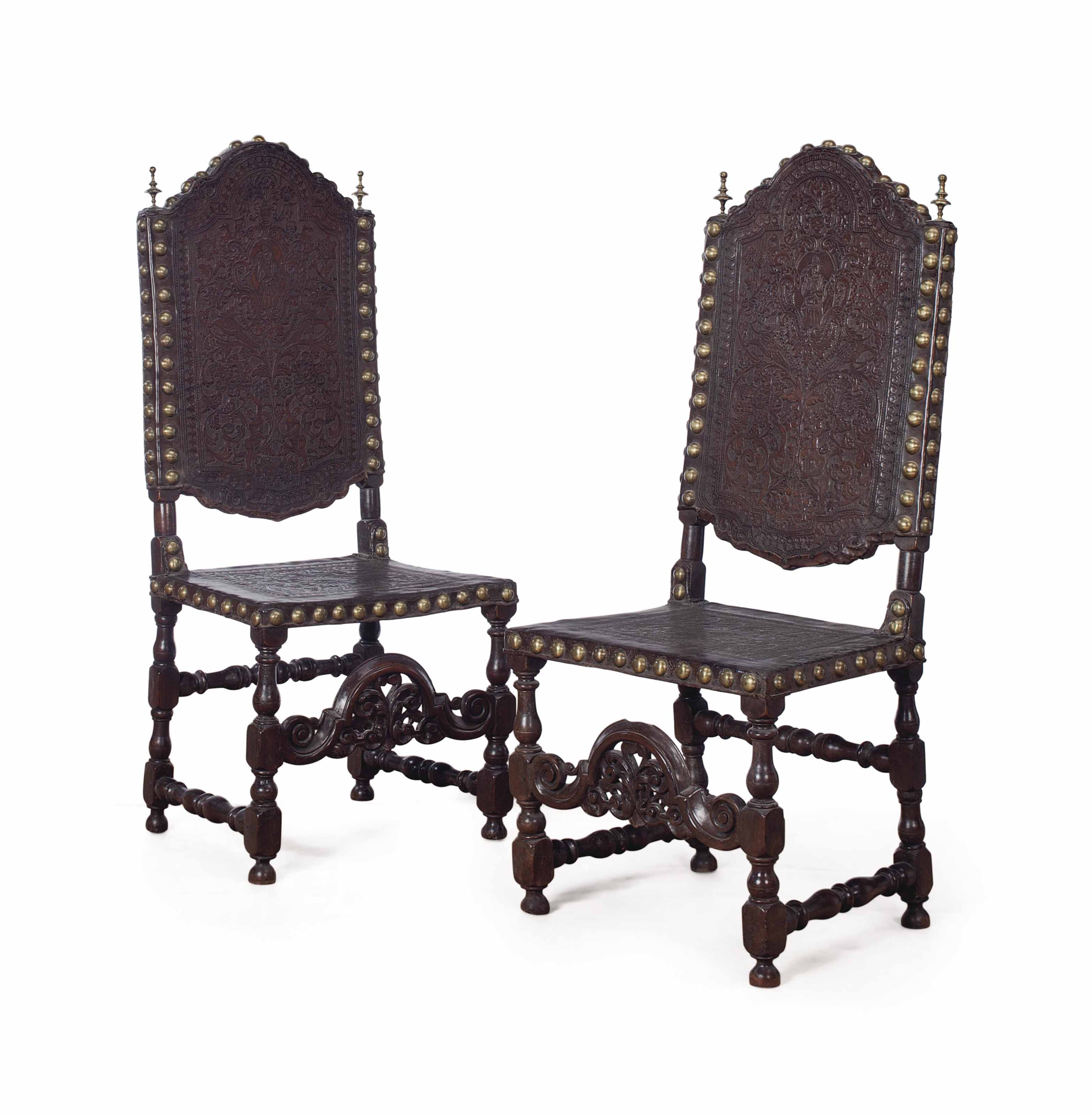 A SET OF SIX SPANISH WALNUT AND EMBOSSED LEATHER DINING CHAIRS