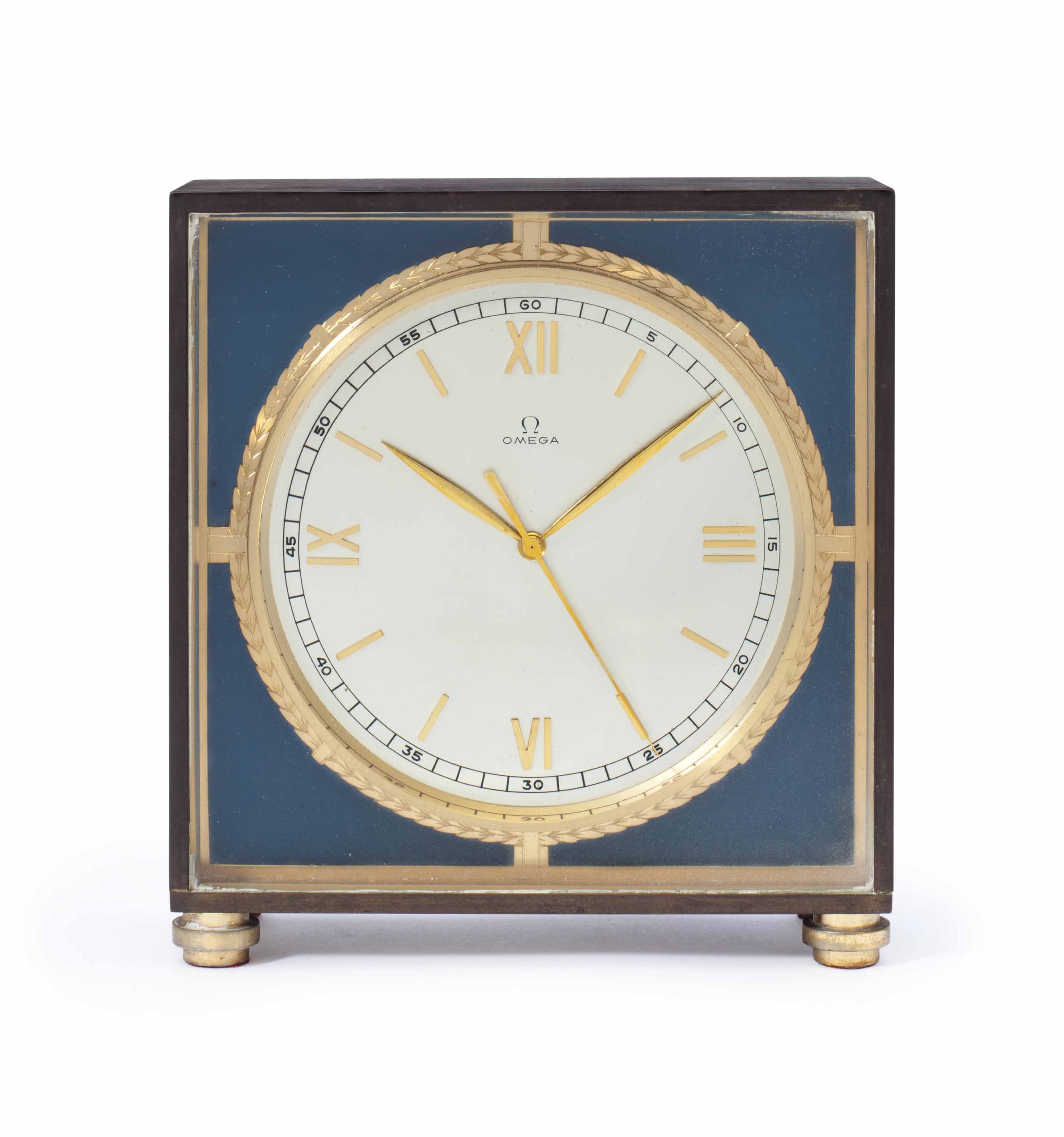 Omega. A Brass Eight Day Desk Clock with Center Seconds and Original