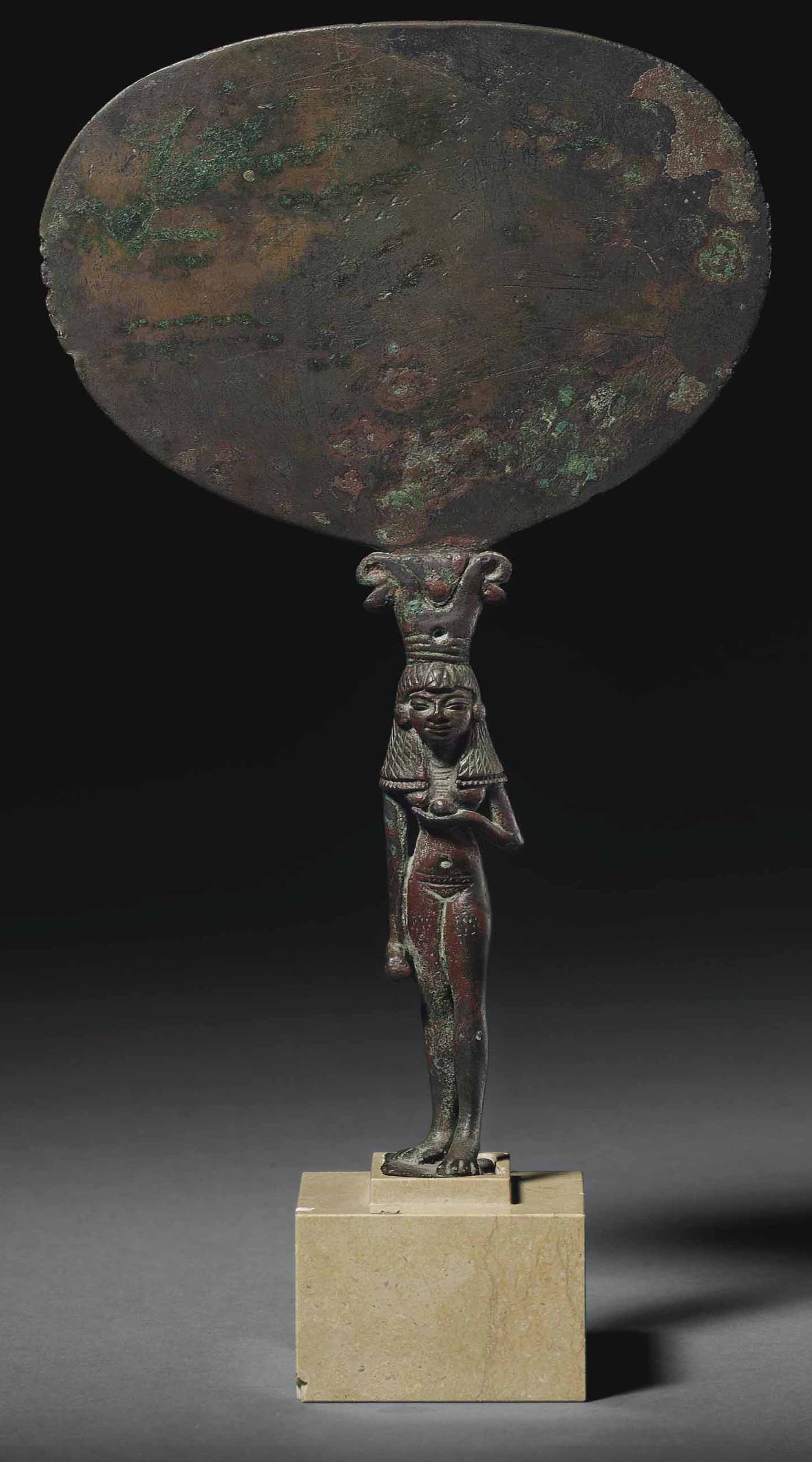 AN EGYPTIAN BRONZE MIRROR , NEW KINGDOM, EARLY TO MID 18TH DYNASTY