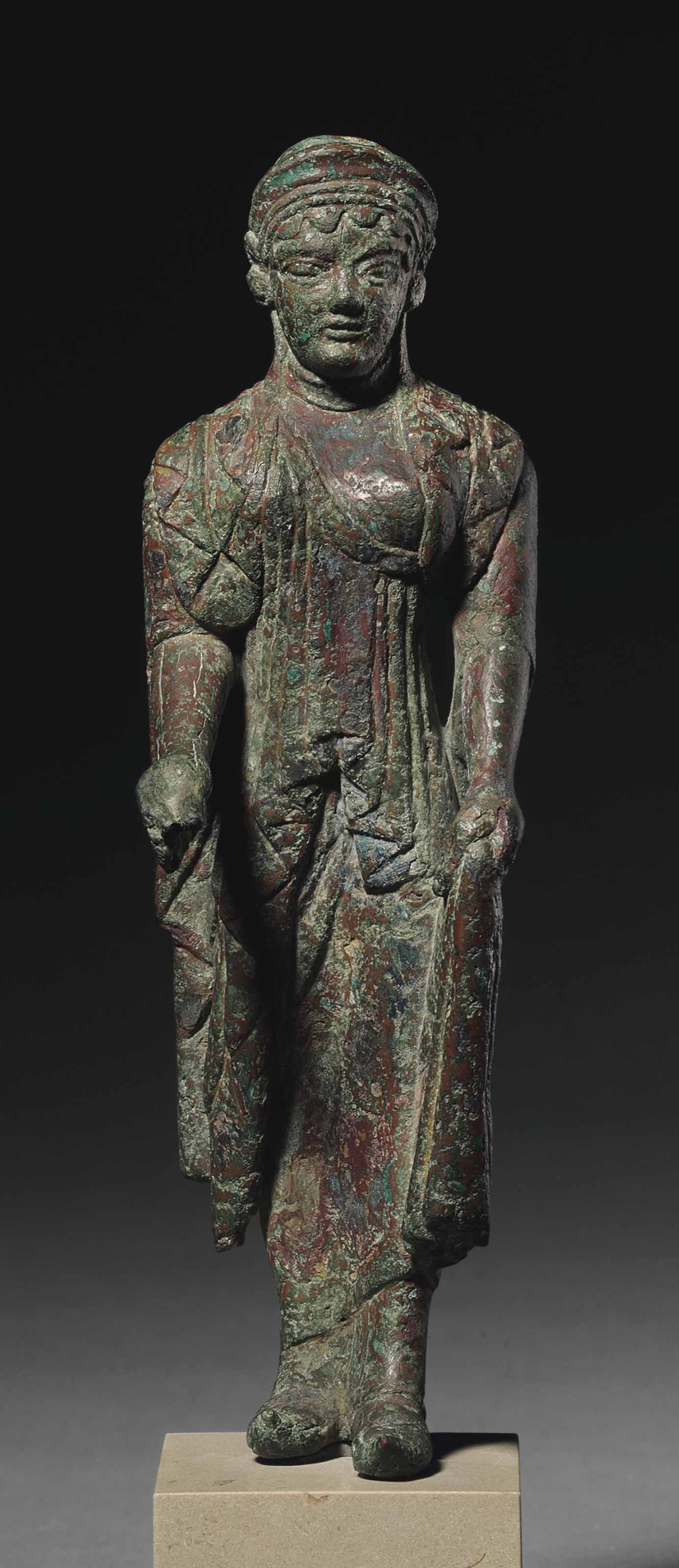 AN ETRUSCAN BRONZE KORE ARCHAIC PERIOD CIRCA 500 480 B C Christie s