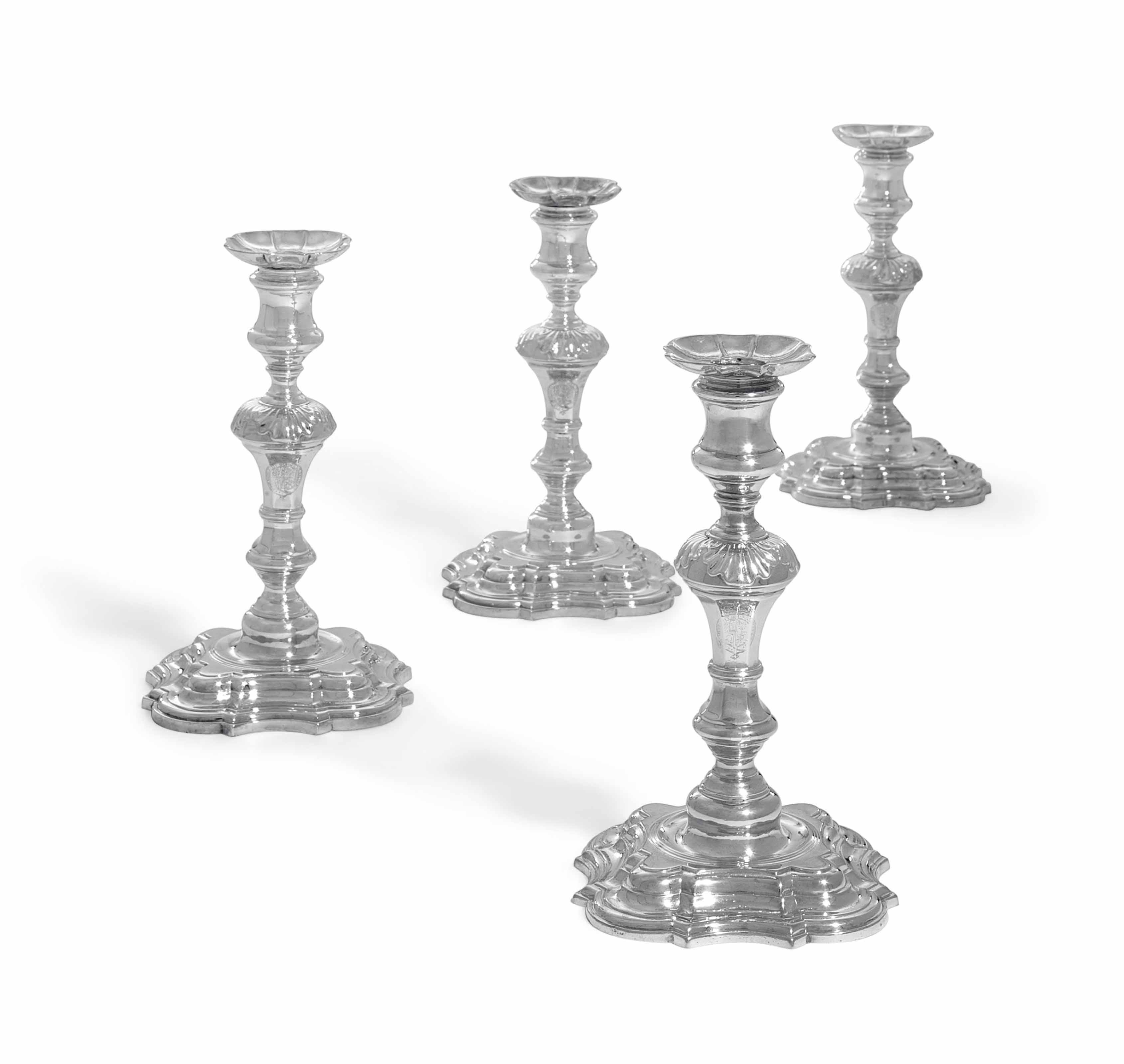 A GERMAN ROYAL CANDLESTICK AND THREE LATER MATCHING CANDLESTICKS , ONE