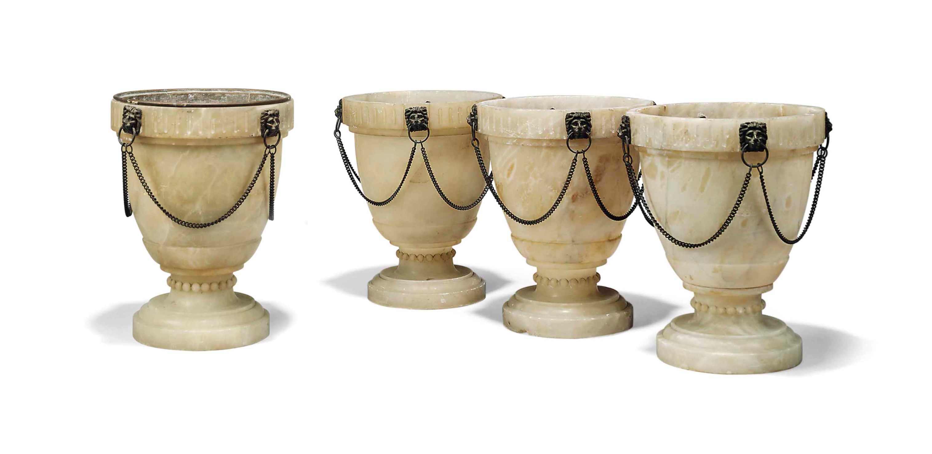 A SET OF FOUR METALMOUNTED AND CARVED ALABASTER VASES, SECOND HALF