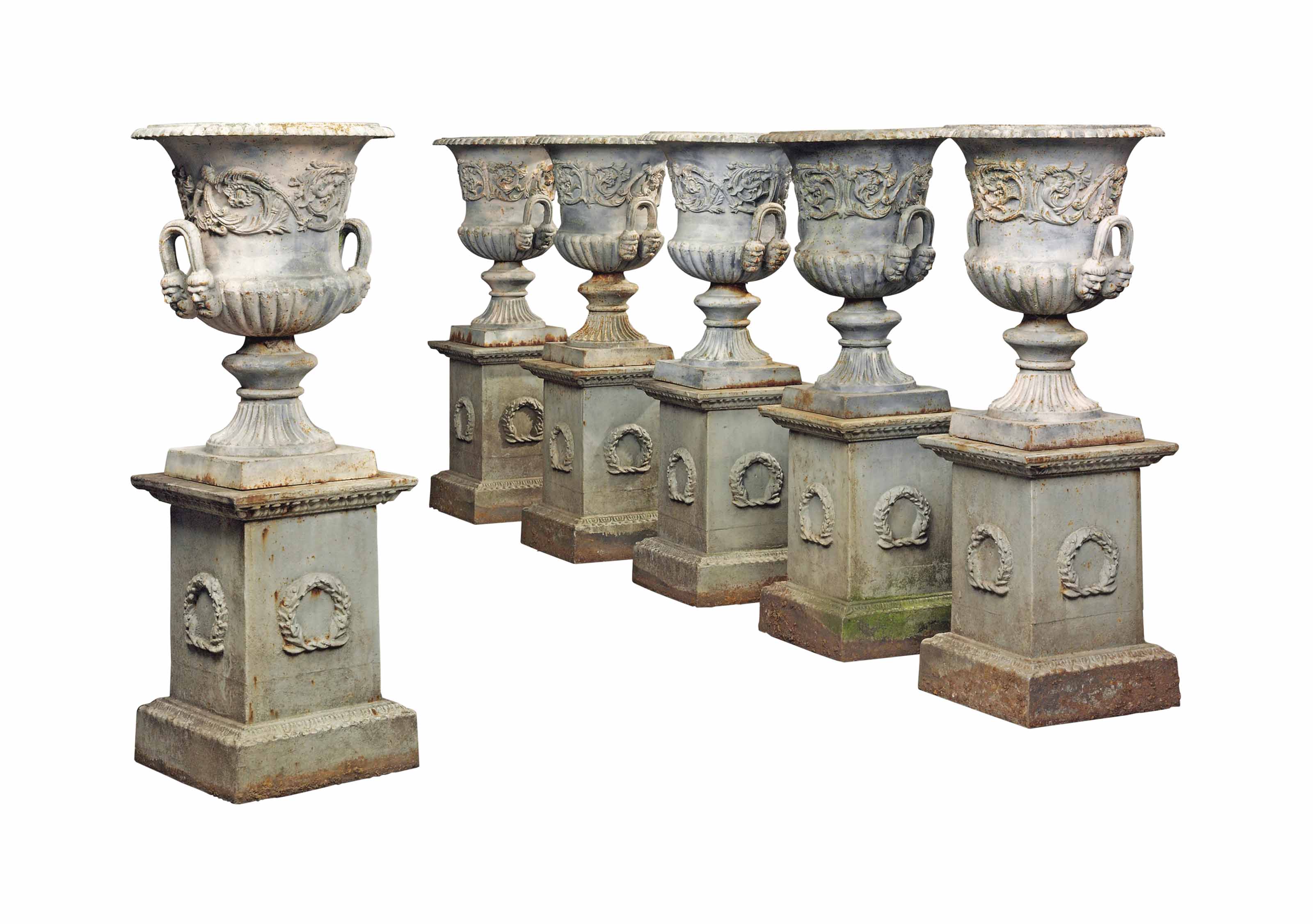 A SET OF SIX LATE VICTORIAN CASTIRON CAMPANASHAPED GARDEN URNS ON