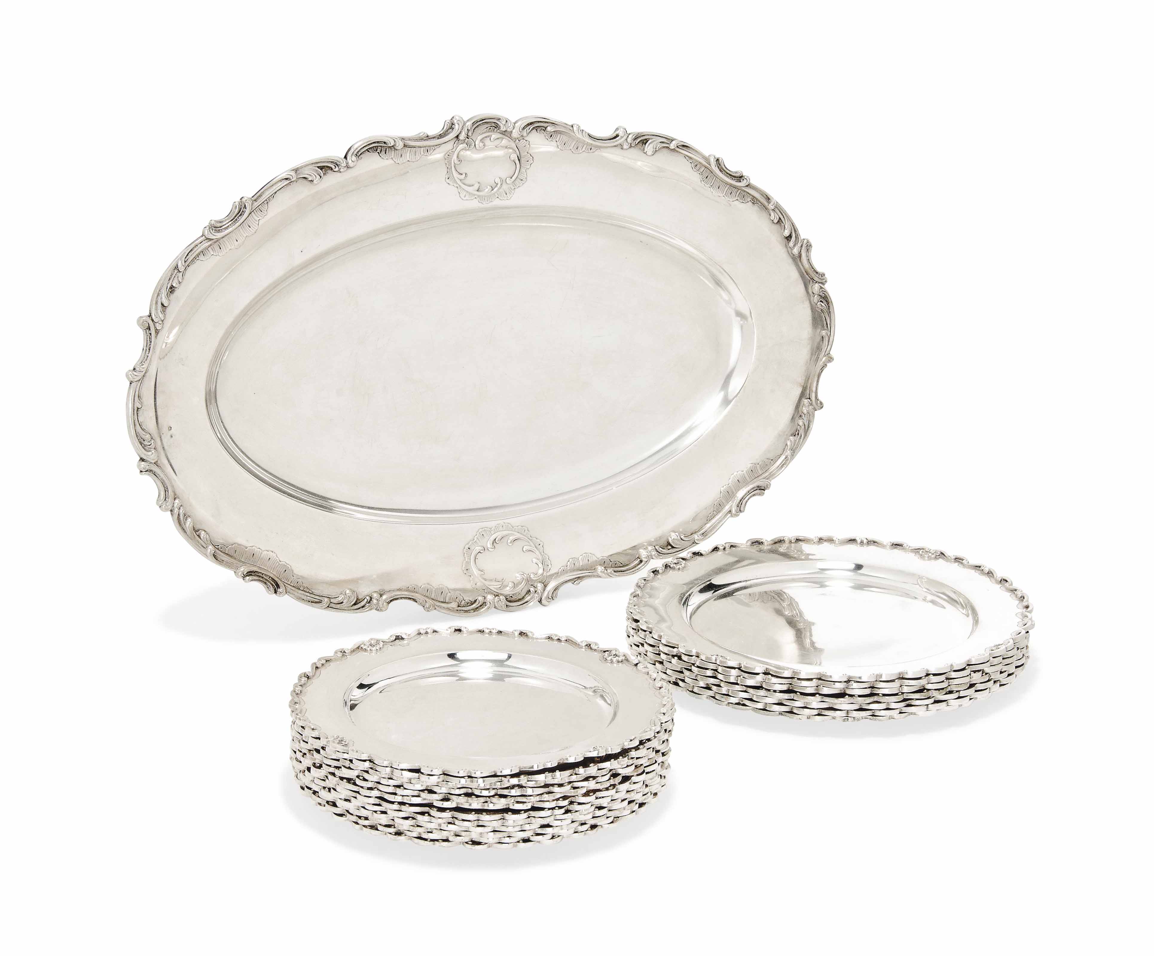 A SUITE OF PORTUGUESE SILVER COMPRISING TWELVE SIDE PLATES AND SEVEN