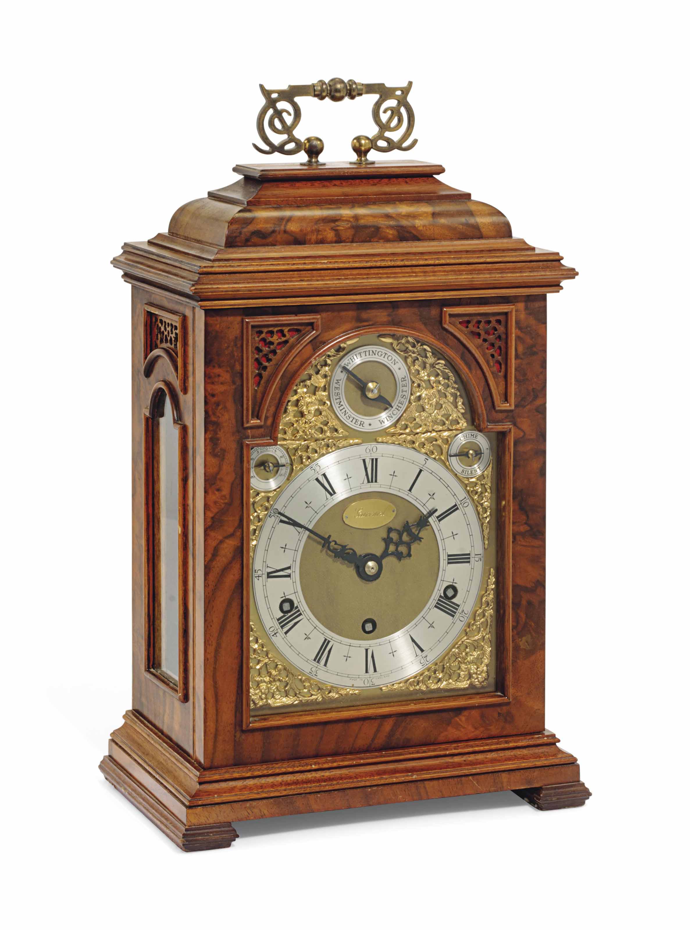 A WALNUT QUARTERCHIMING TABLE CLOCK , ELLIOT, LONDON, RETAILED BY