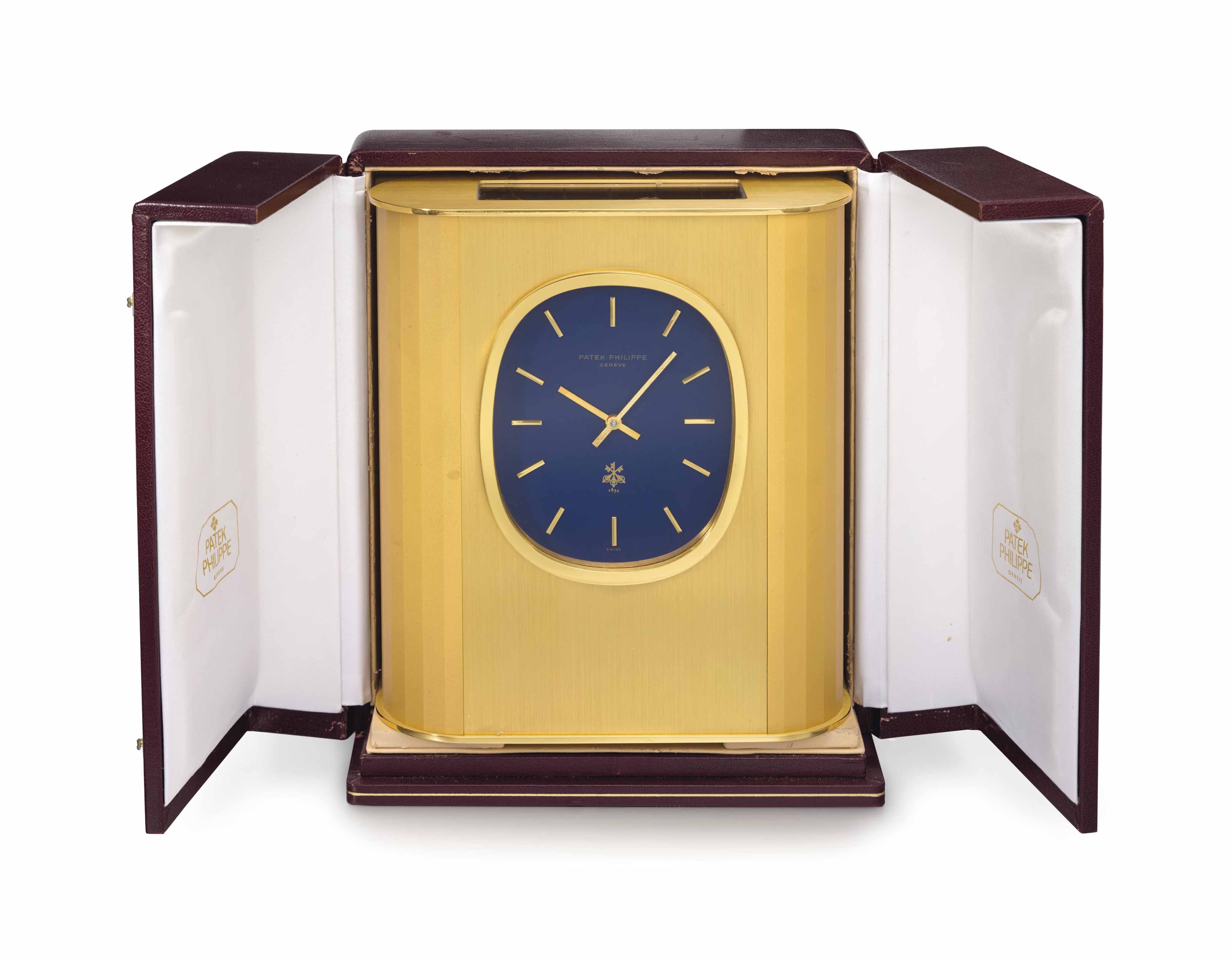 Patek Philippe. A gilt brass rectangular solarpowered desk clock
