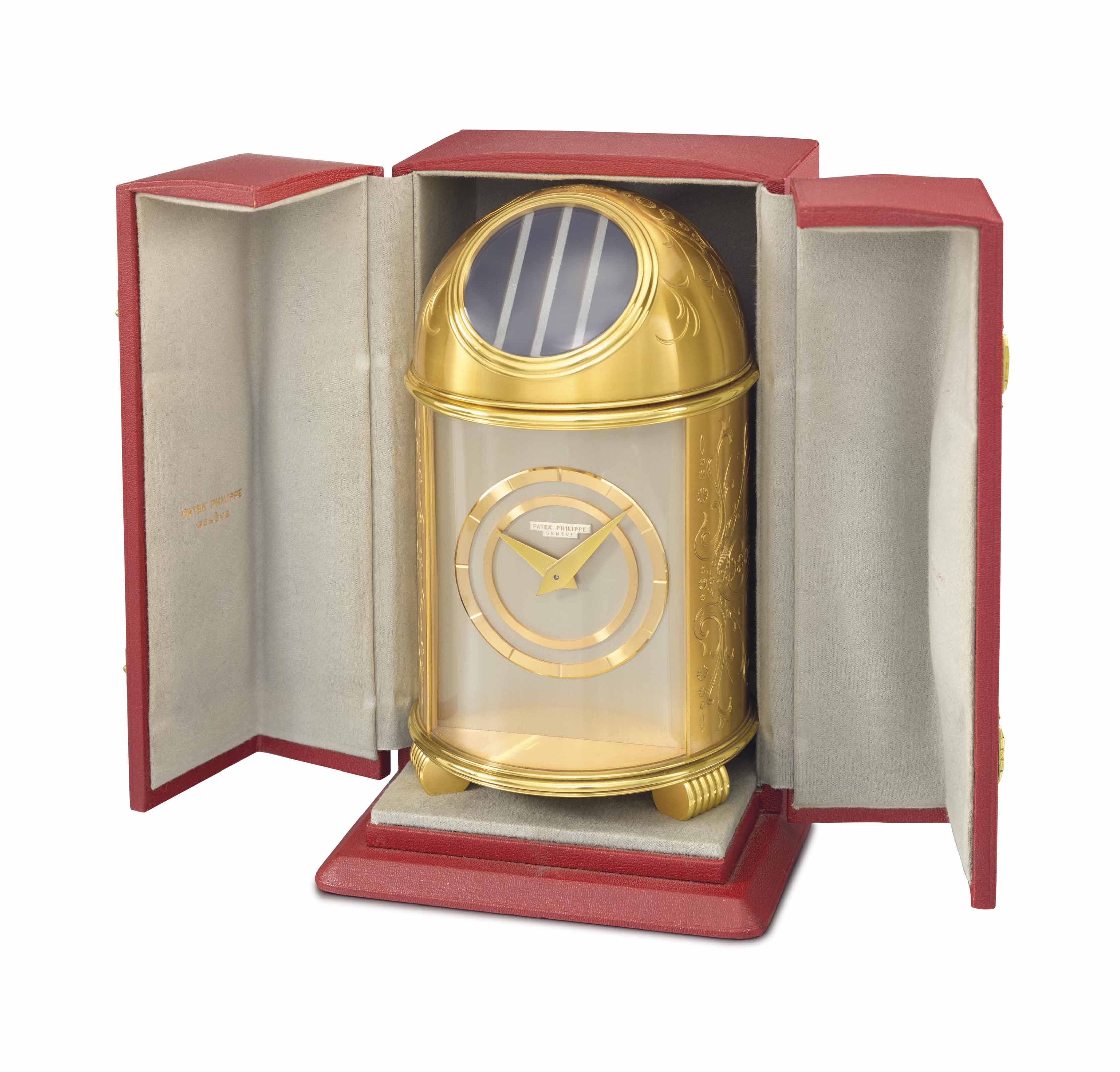 Patek Philippe. A fine gilt brass solarpowered dome table clock and