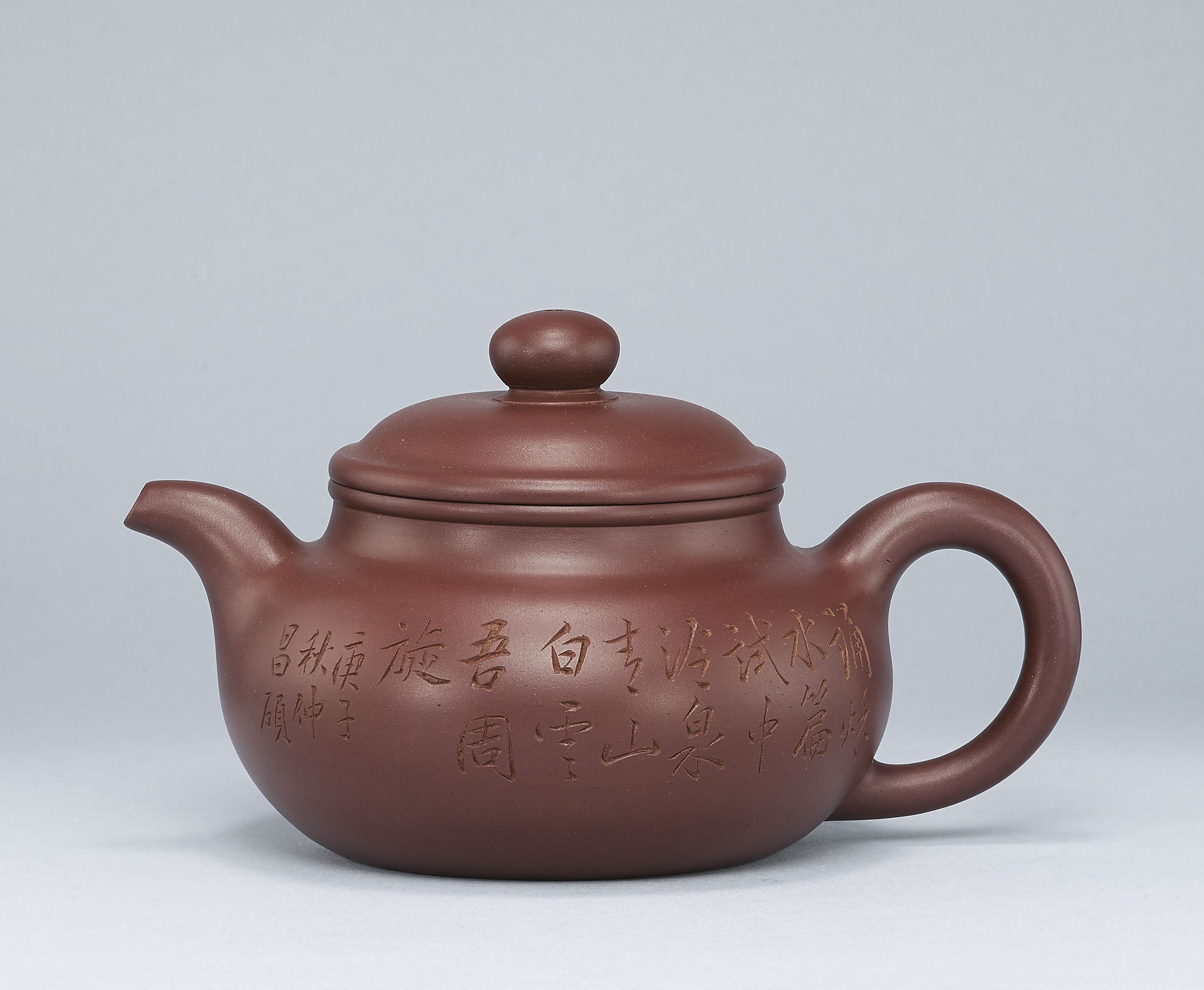 AN INSCRIBED YIXING TEAPOT