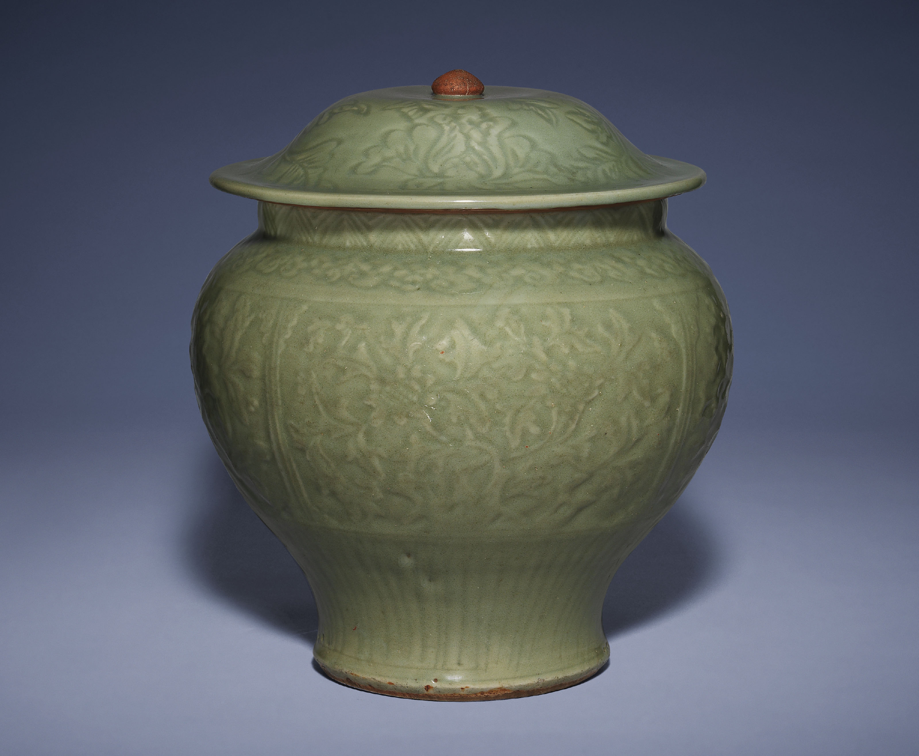A CARVED LONGQUAN CELADON JAR AND COVER , MING DYNASTY, 15TH CENTURY