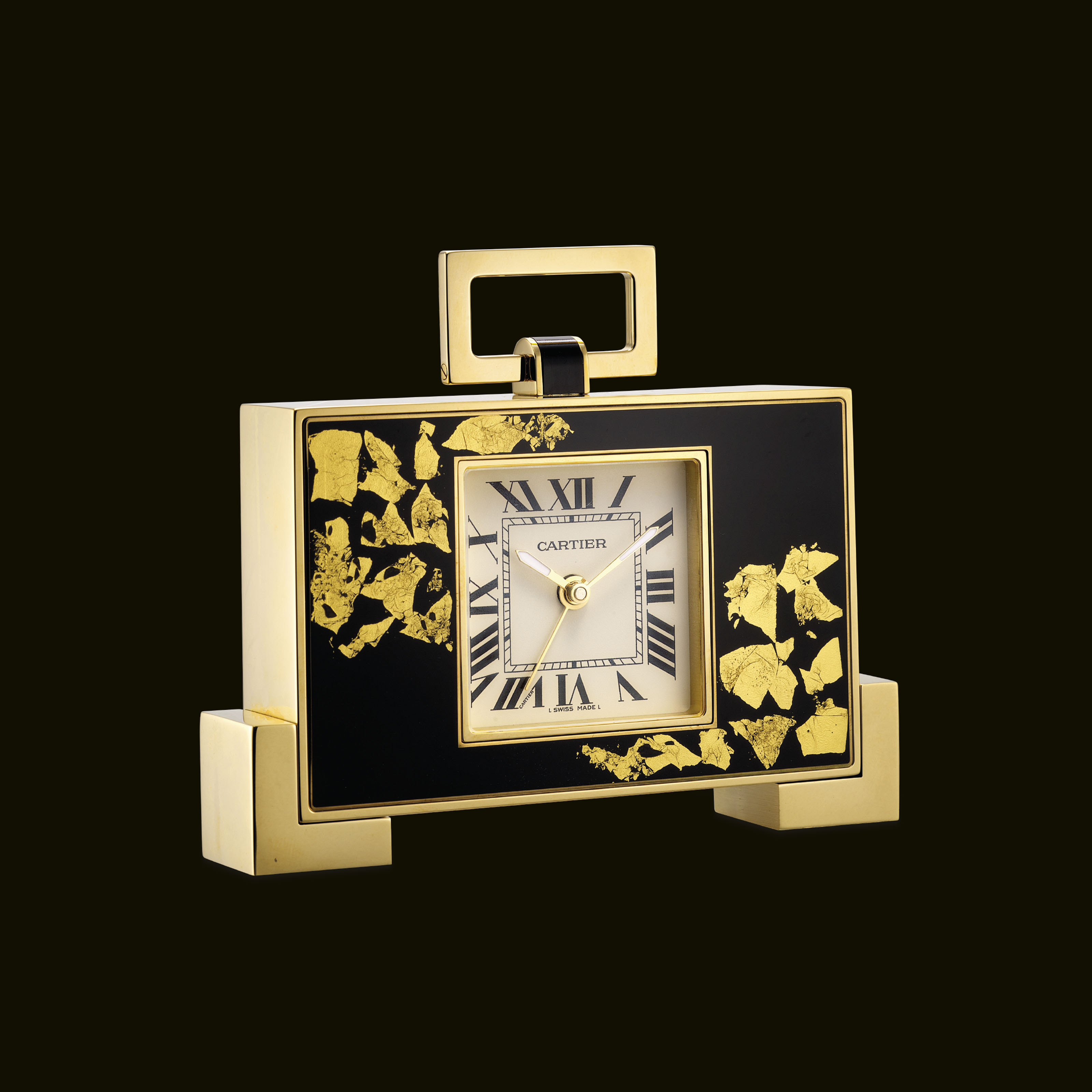 CARTIER. A GILT, LACQUER AND GOLD FOIL LIMITED EDITION DESK CLOCK WITH