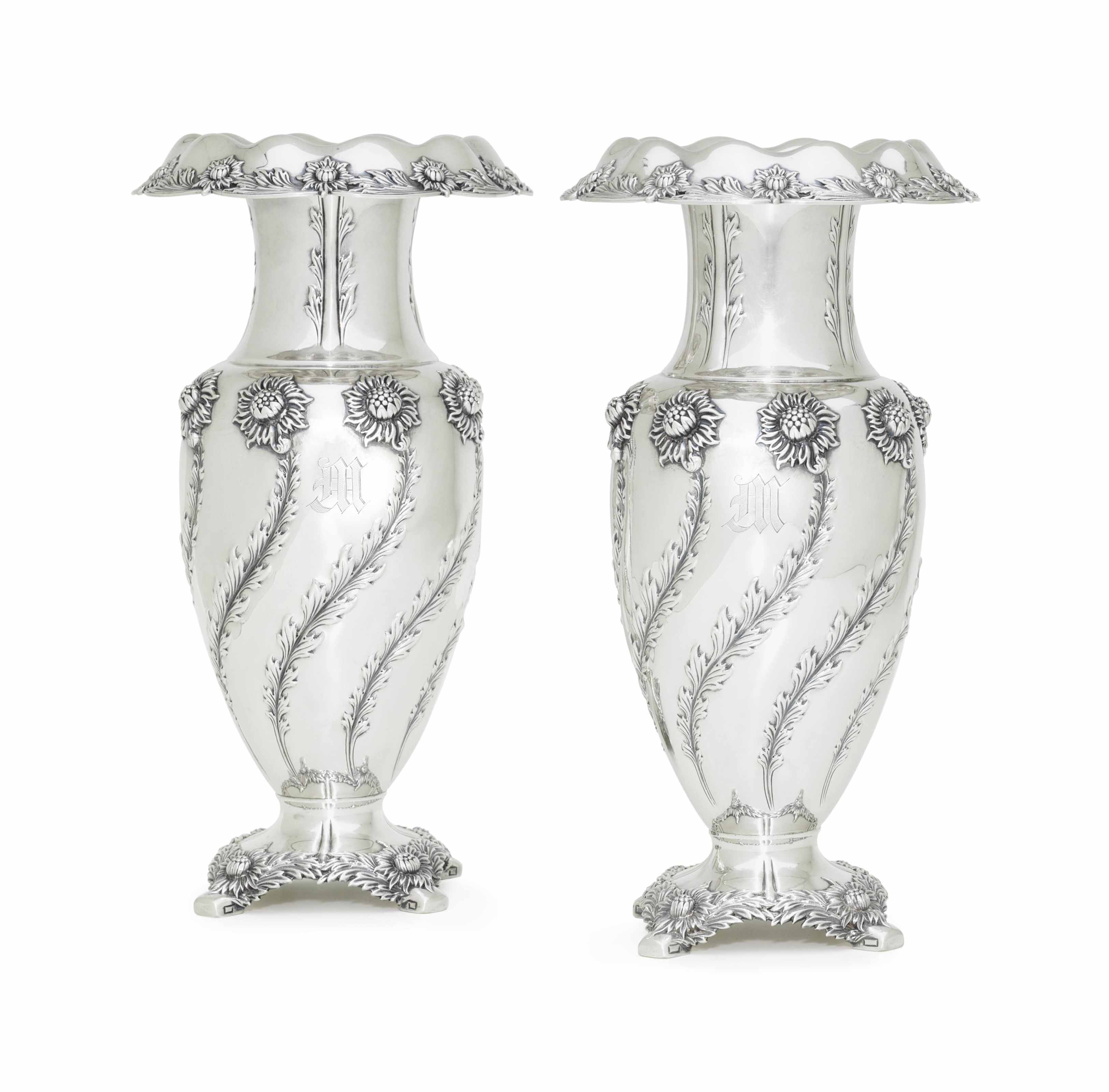 A PAIR OF SILVER VASES