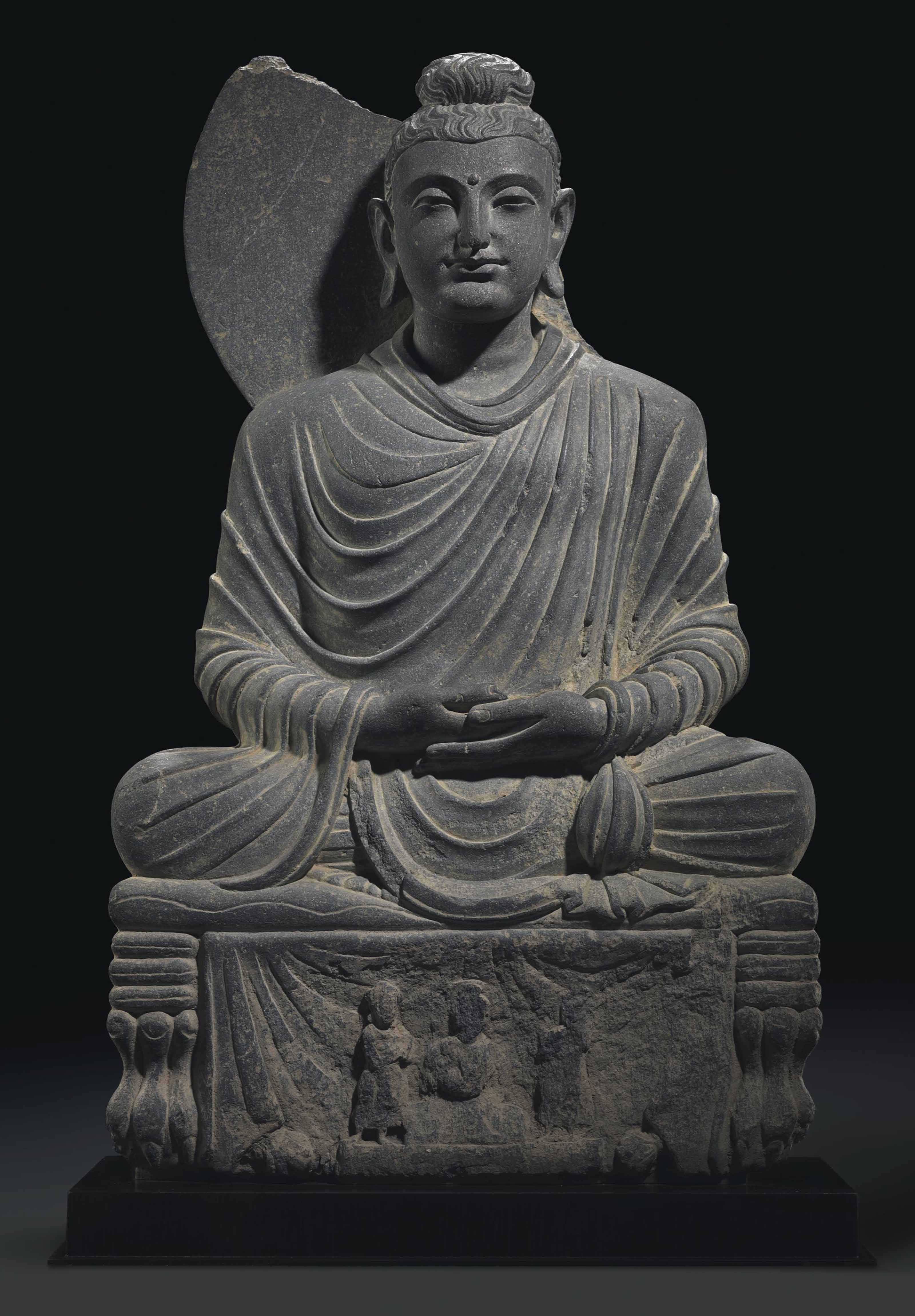 A GRAY SCHIST FIGURE OF A SEATED BUDDHA , GANDHARA, 2ND/3RD CENTURY