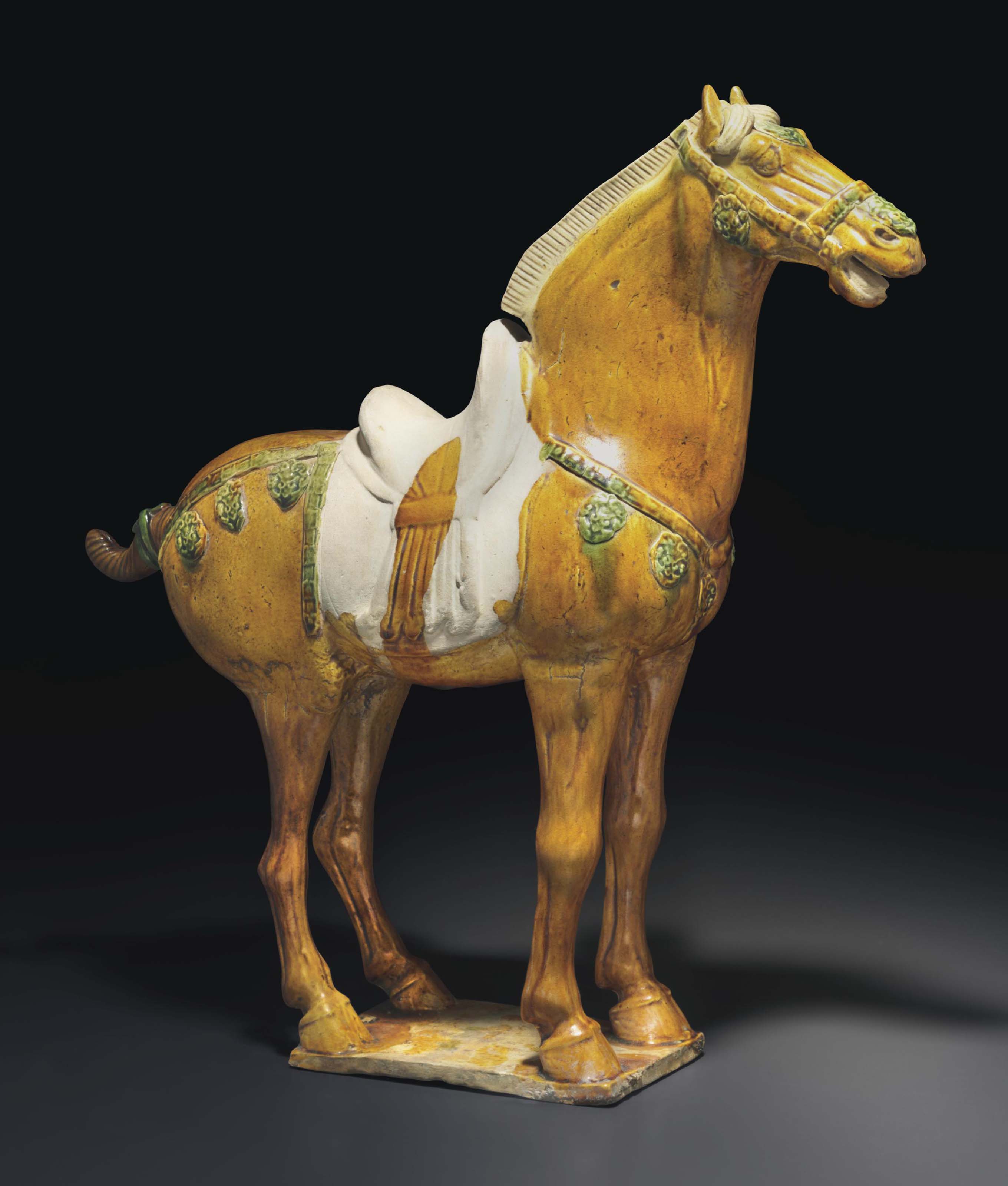 A SANCAIGLAZED POTTERY FIGURE OF A HORSE , TANG DYNASTY (AD 618907