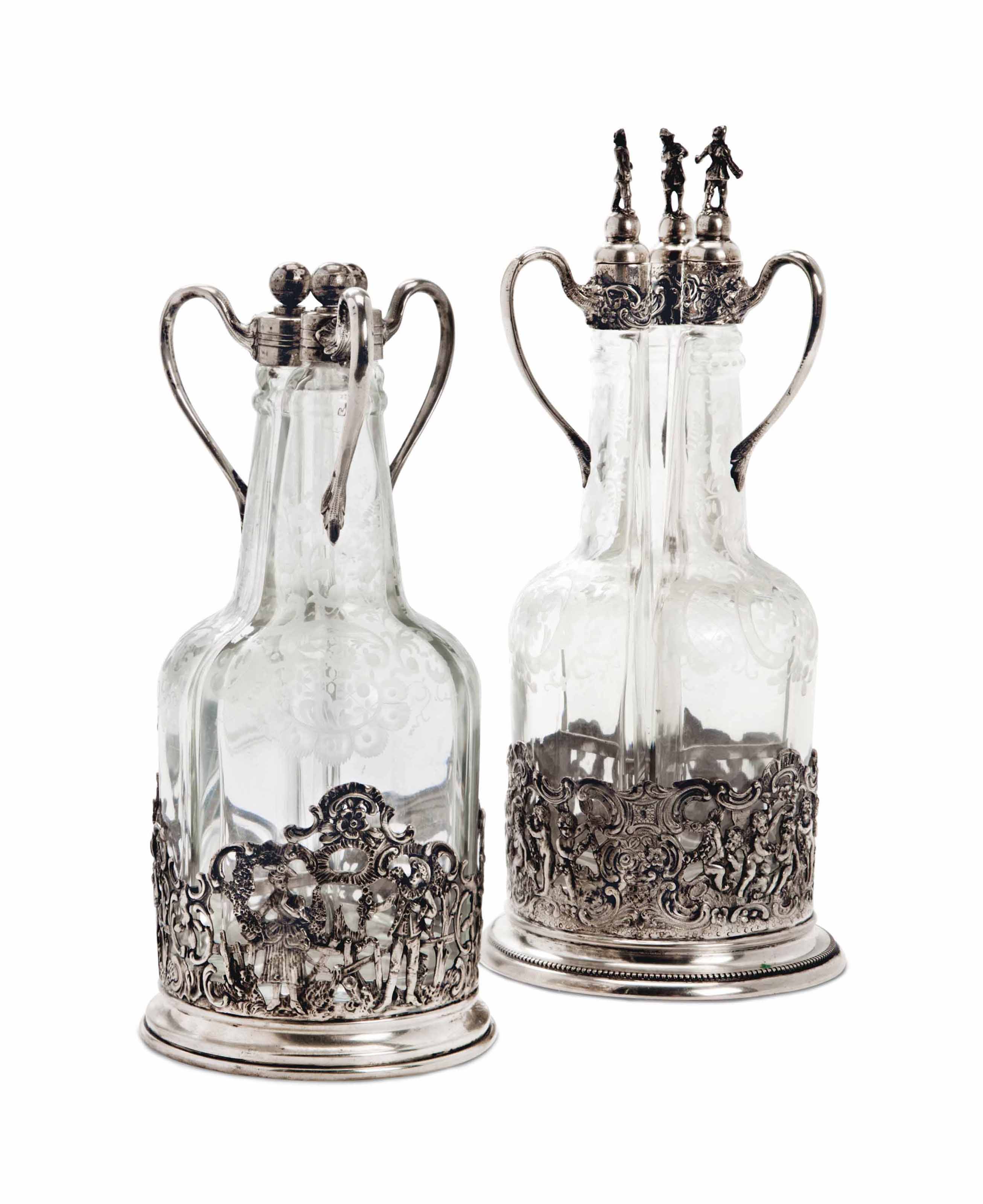 A MATCHED PAIR OF GERMAN SILVERMOUNTED ETCHEDGLASS CRUET SETS
