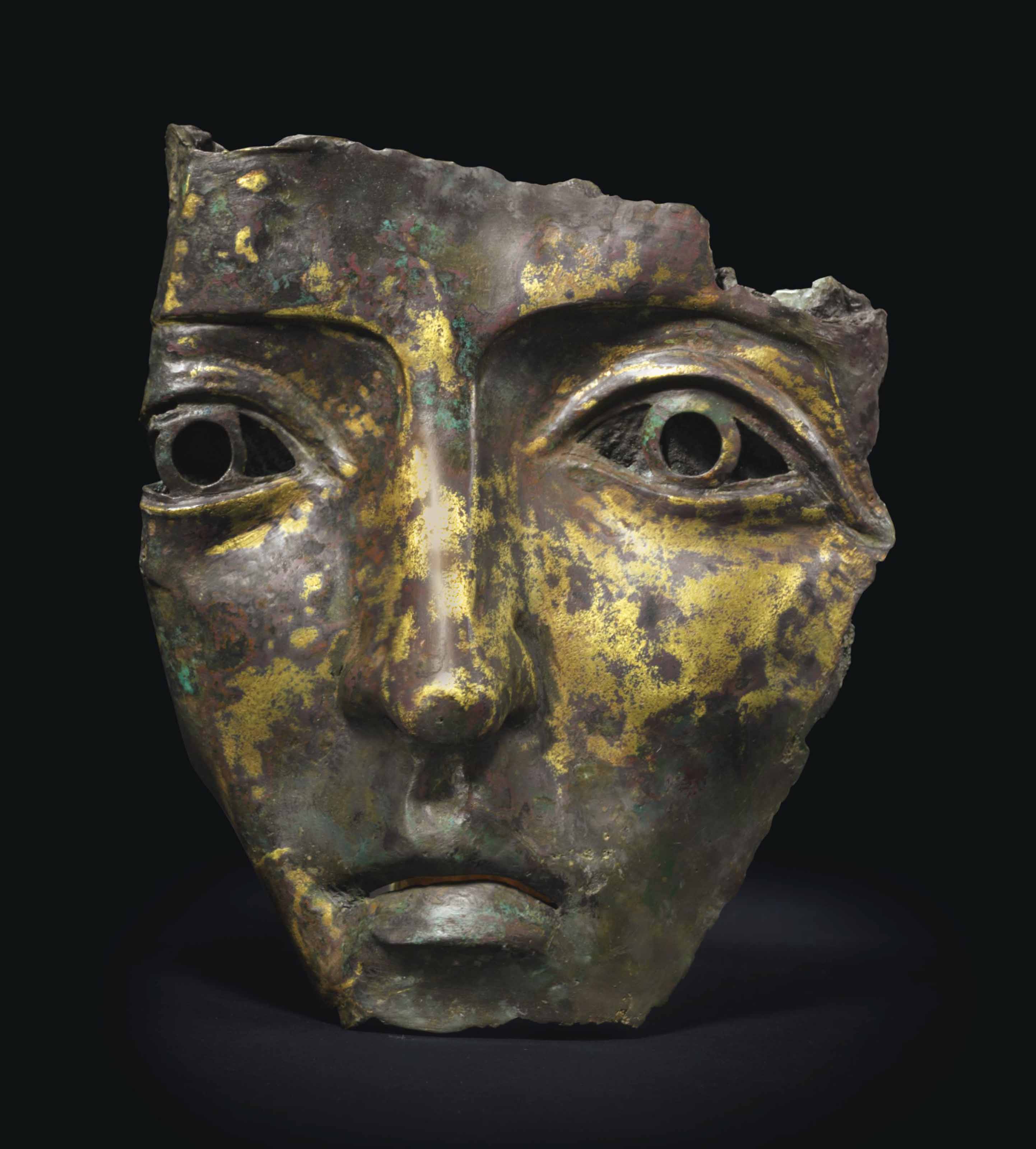 A ROMAN GILT BRONZE PARADE HELMET MASK , CIRCA 2ND CENTURY A.D