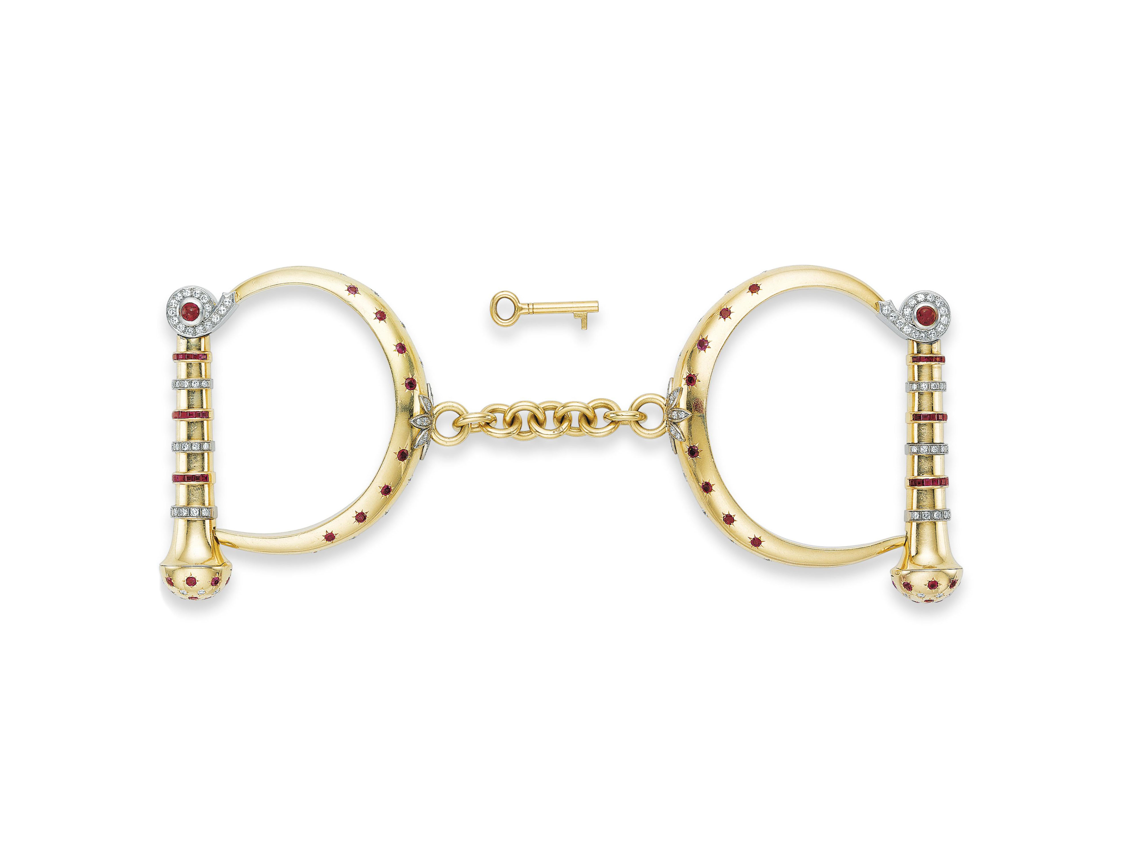A RUBY, DIAMOND AND GOLD HANDCUFF BRACELET, BY KUTCHINSKY