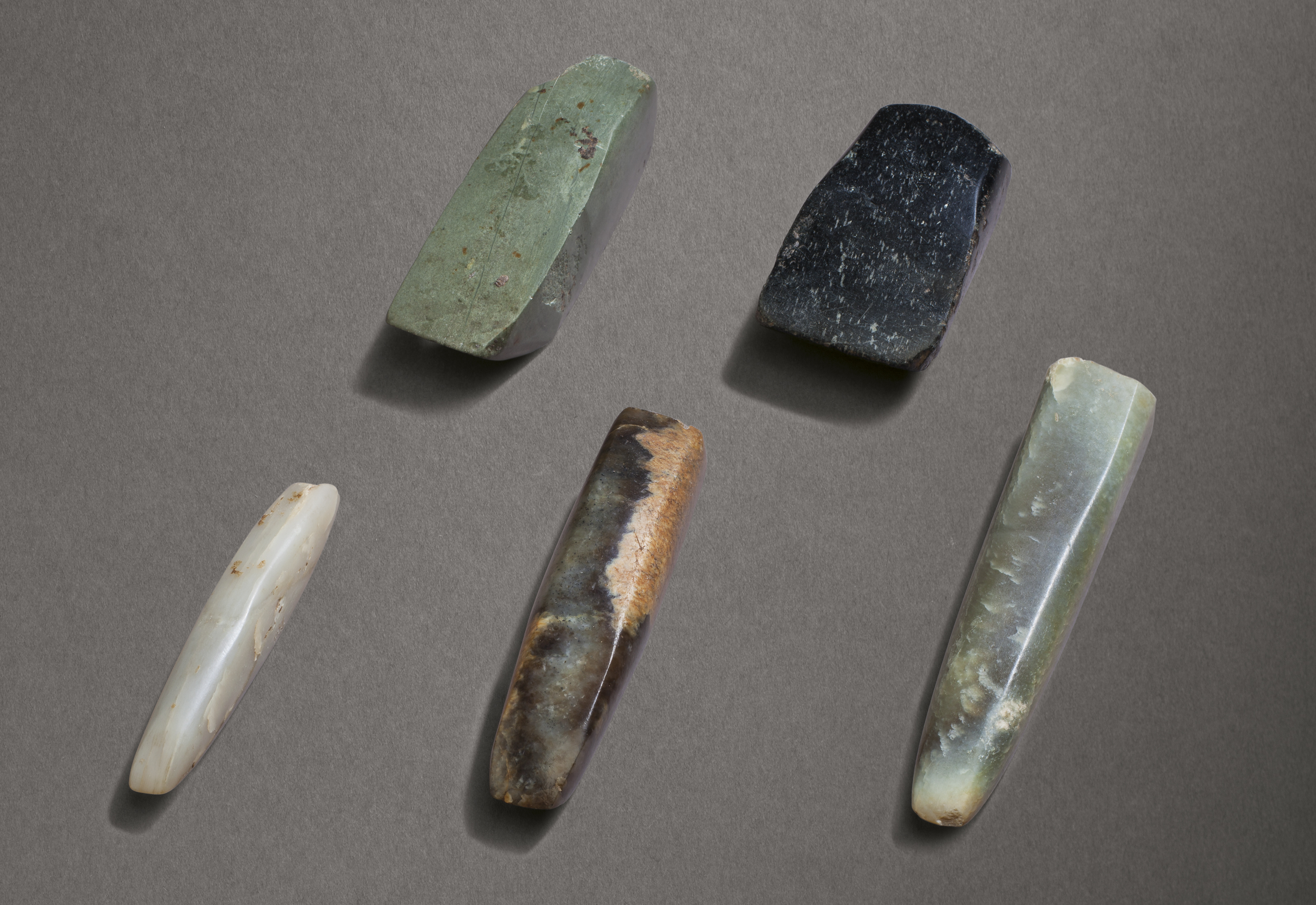 A GROUP OF FIVE JADE AND STONE HAND TOOLS, CHINA, NEOLITHIC PERIOD