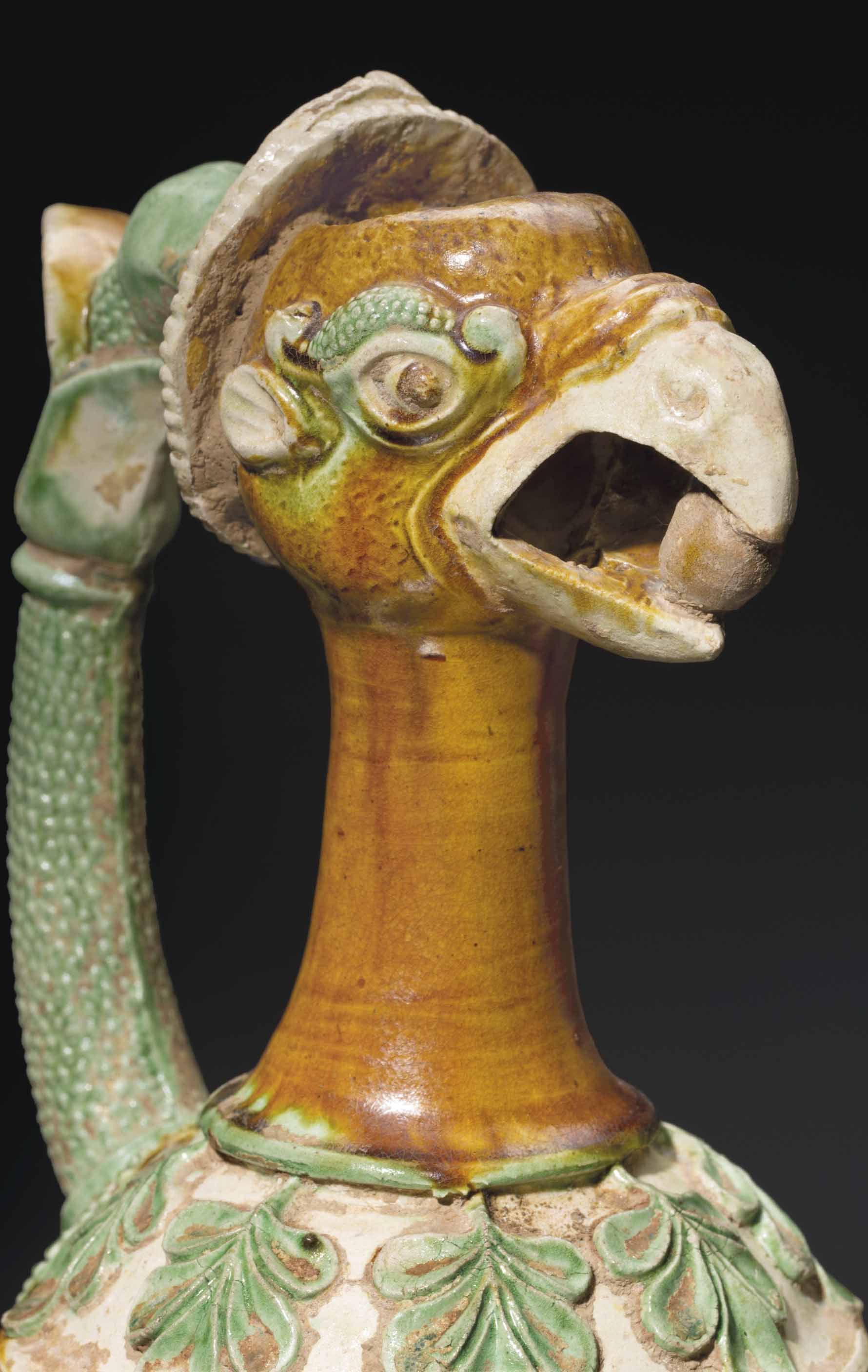 A VERY RARE SANCAIGLAZED POTTERY PHOENIXHEAD EWER , CHINA, TANG