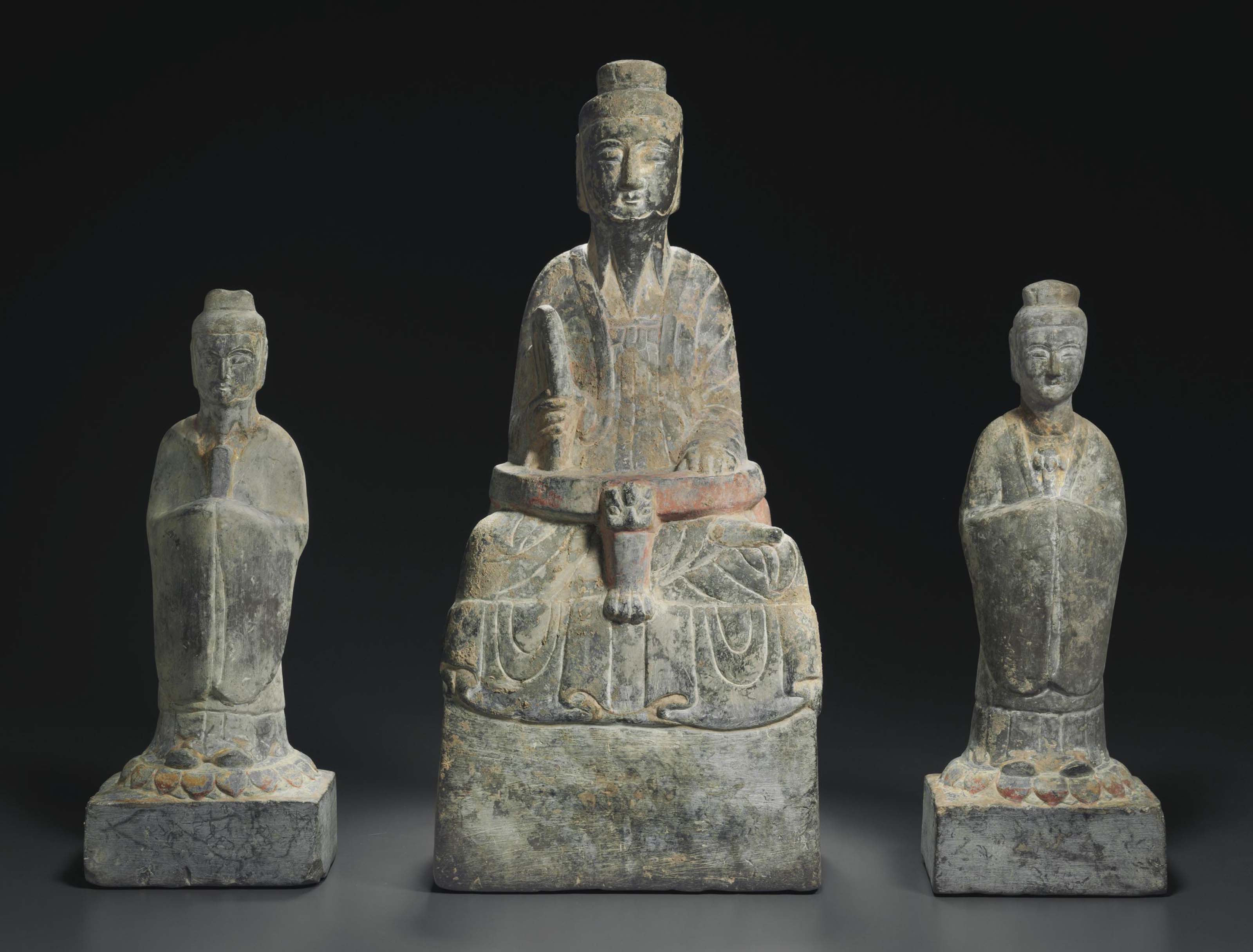 A PAINTED GREY STONE DAOIST TRIAD , CHINA, SUI DYNASTY (AD 581618
