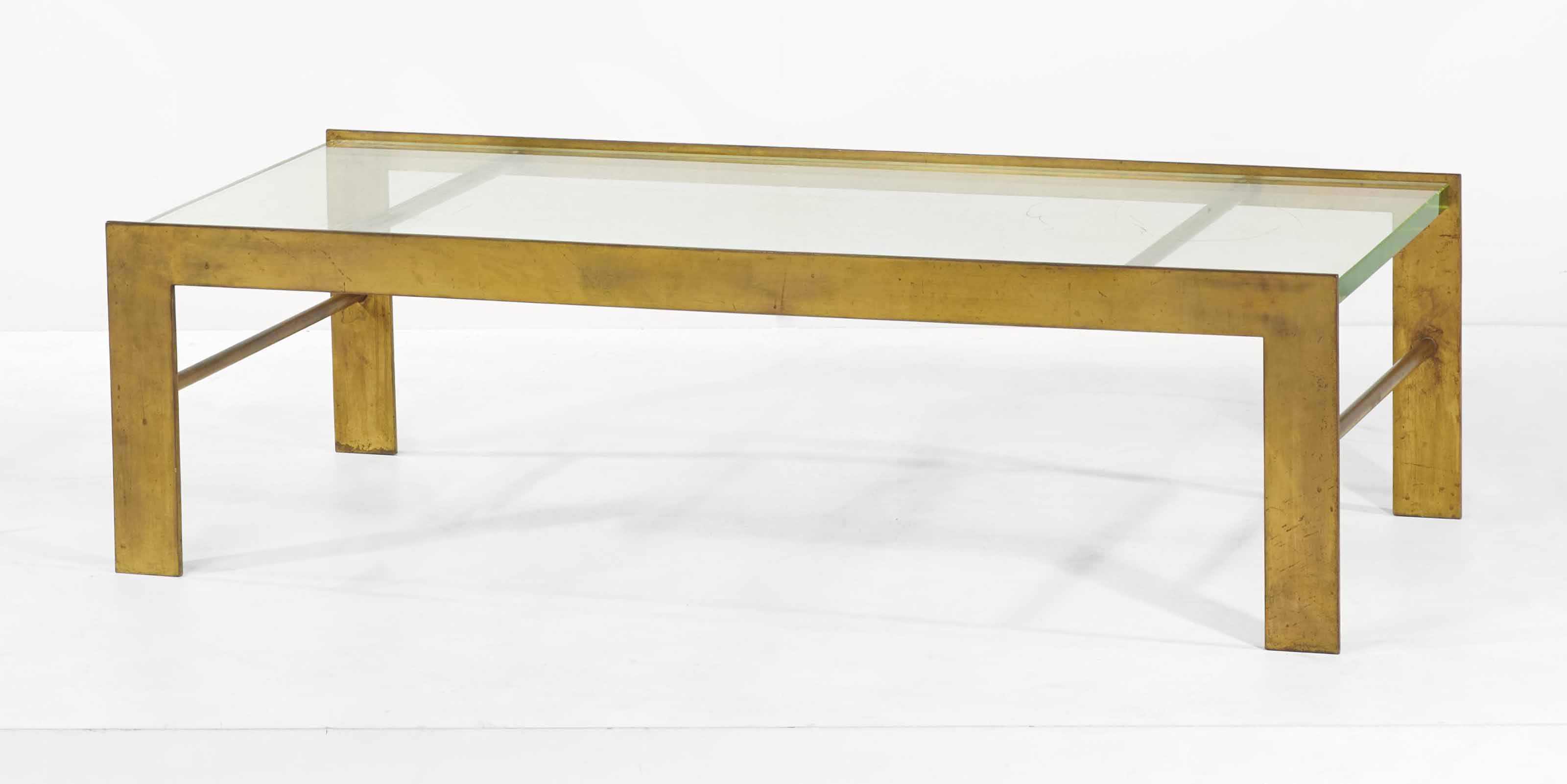Marc du Plantier (1901-1975), Low table, 1934. Gold-patinated steel and the original glass. 40 x 140 x 62 cm (15&frac34; x 55⅛ x 24⅜ in). Sold for &euro;181,500 on 19 May 2015 at Christie&rsquo;s in Paris