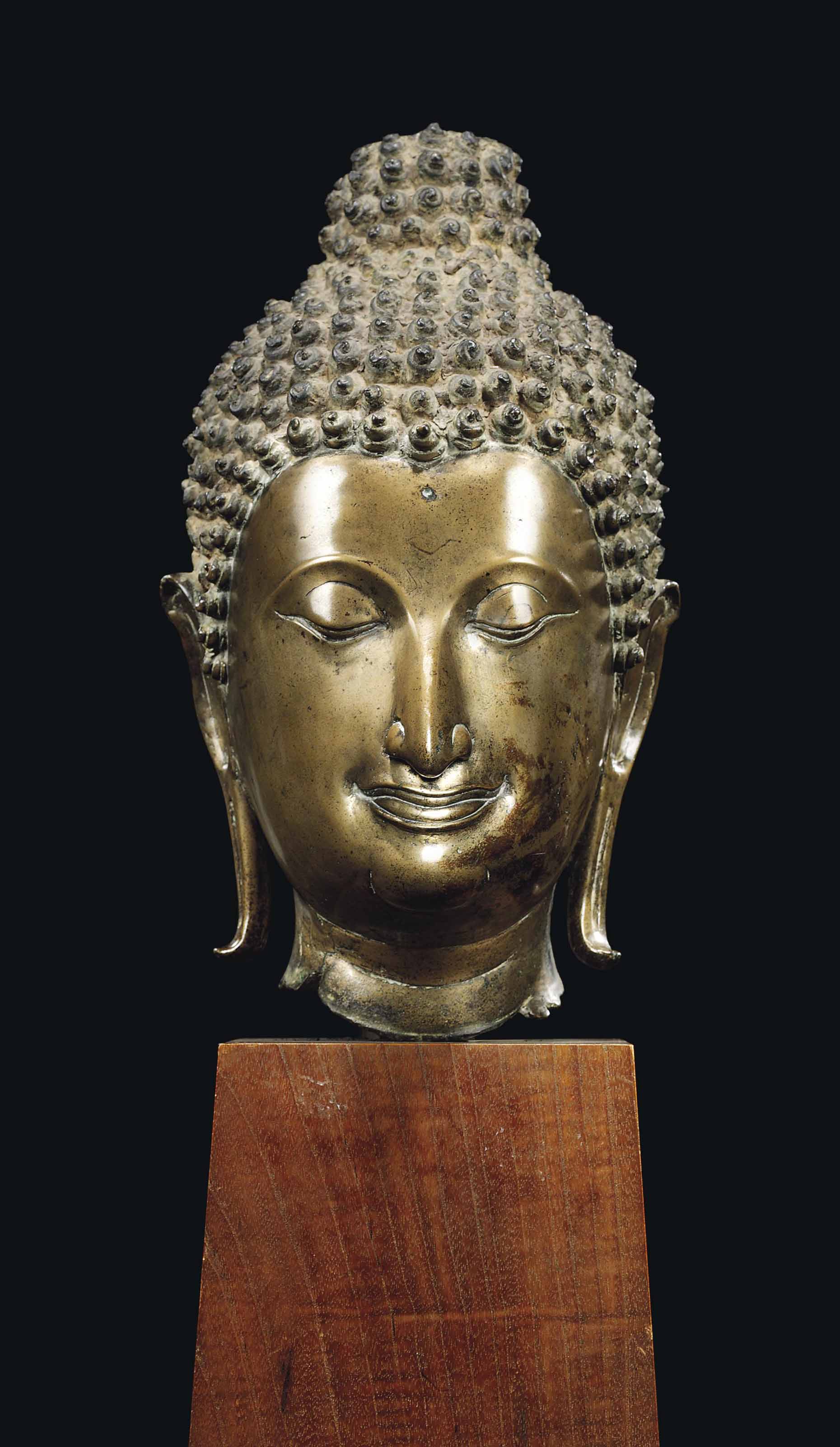 A MONUMENTAL BRONZE HEAD OF BUDDHA , THAILAND, SUKHOTHAI PERIOD, 14TH