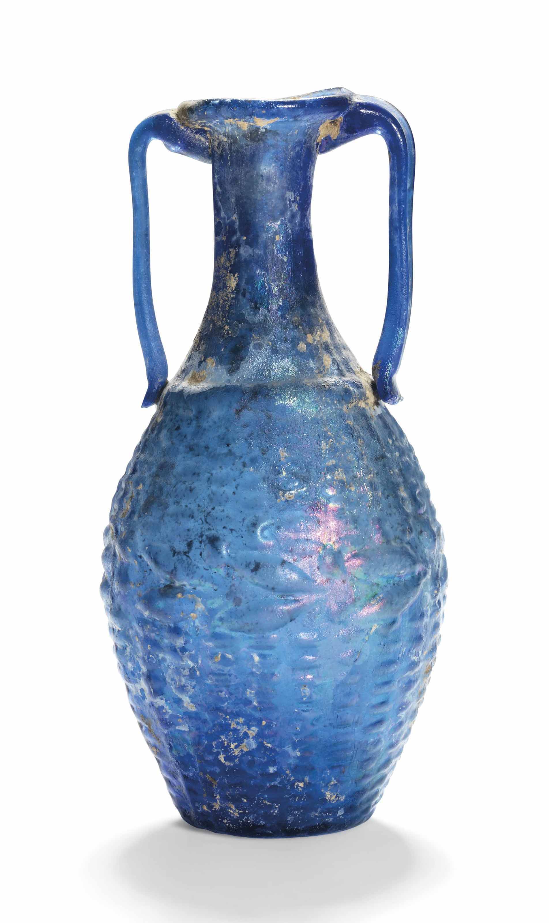A ROMAN COBALT BLUE GLASS AMPHORISKOS WITH BASKET WEAVE PATT...