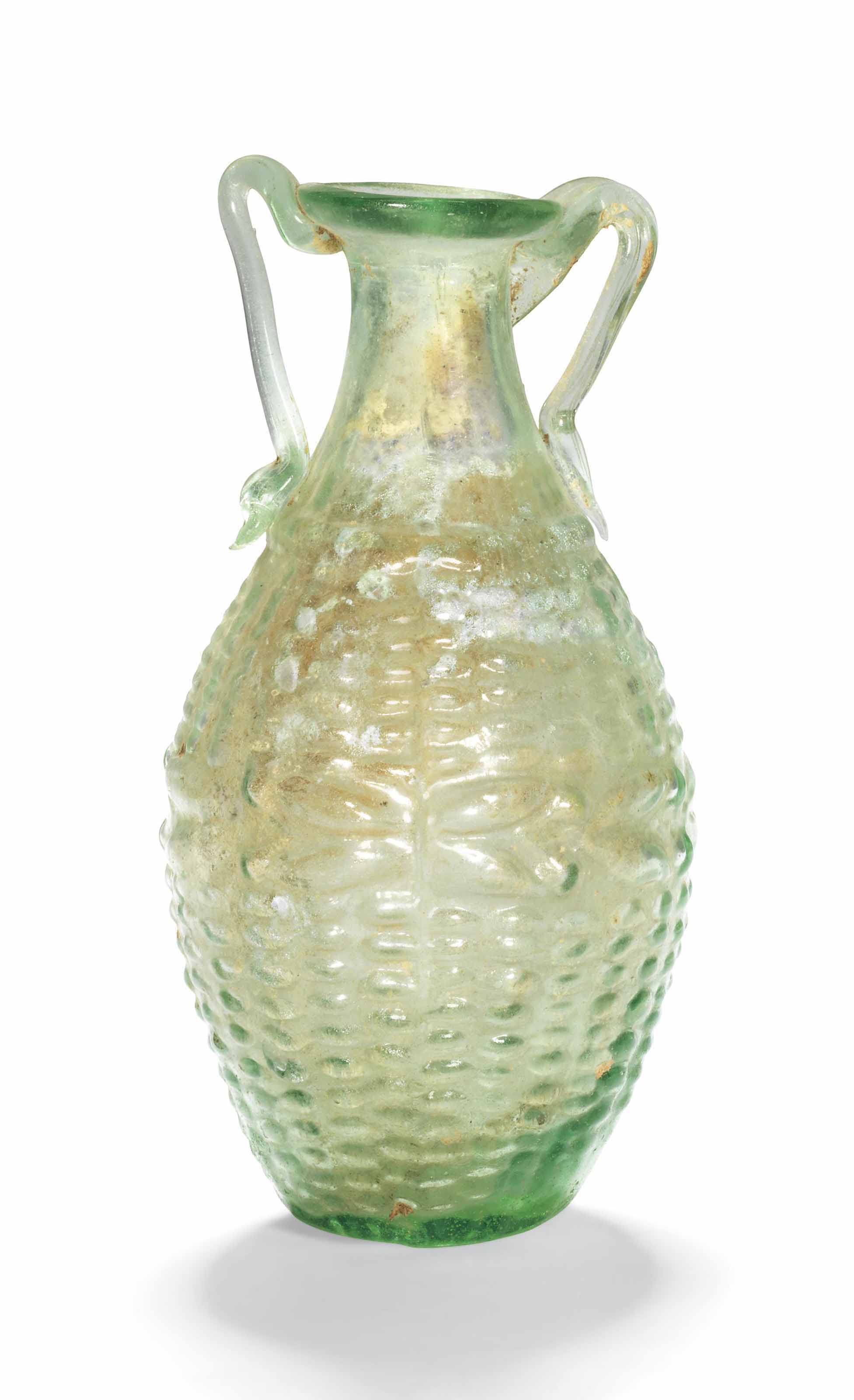 A ROMAN GREEN GLASS AMPHORISKOS WITH BASKET WEAVE PATTERN