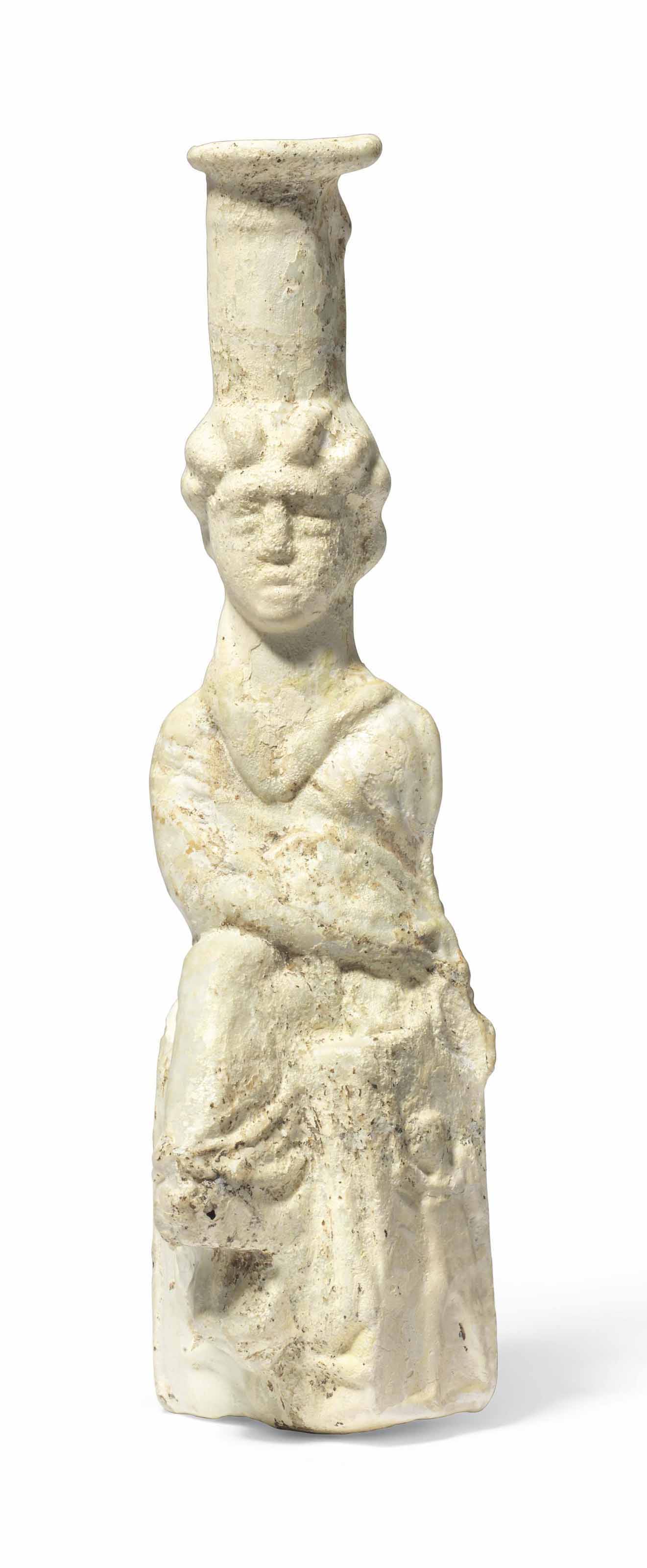 A ROMAN OPAQUE WHITE GLASS BOTTLE IN THE FORM OF TYCHE