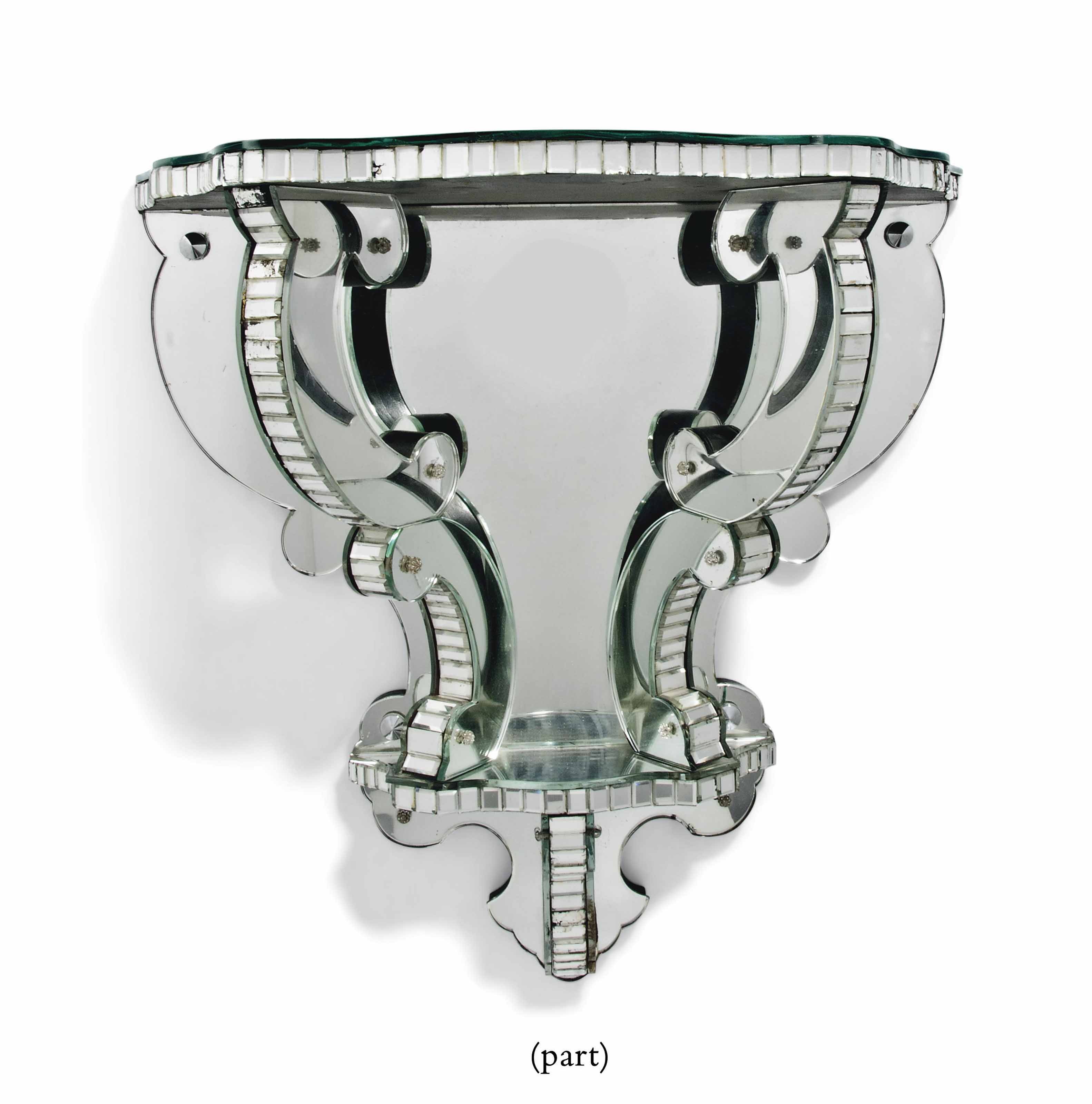 A PAIR OF MIRRORED GLASS WALL BRACKETS , CIRCA 1950S Christie's