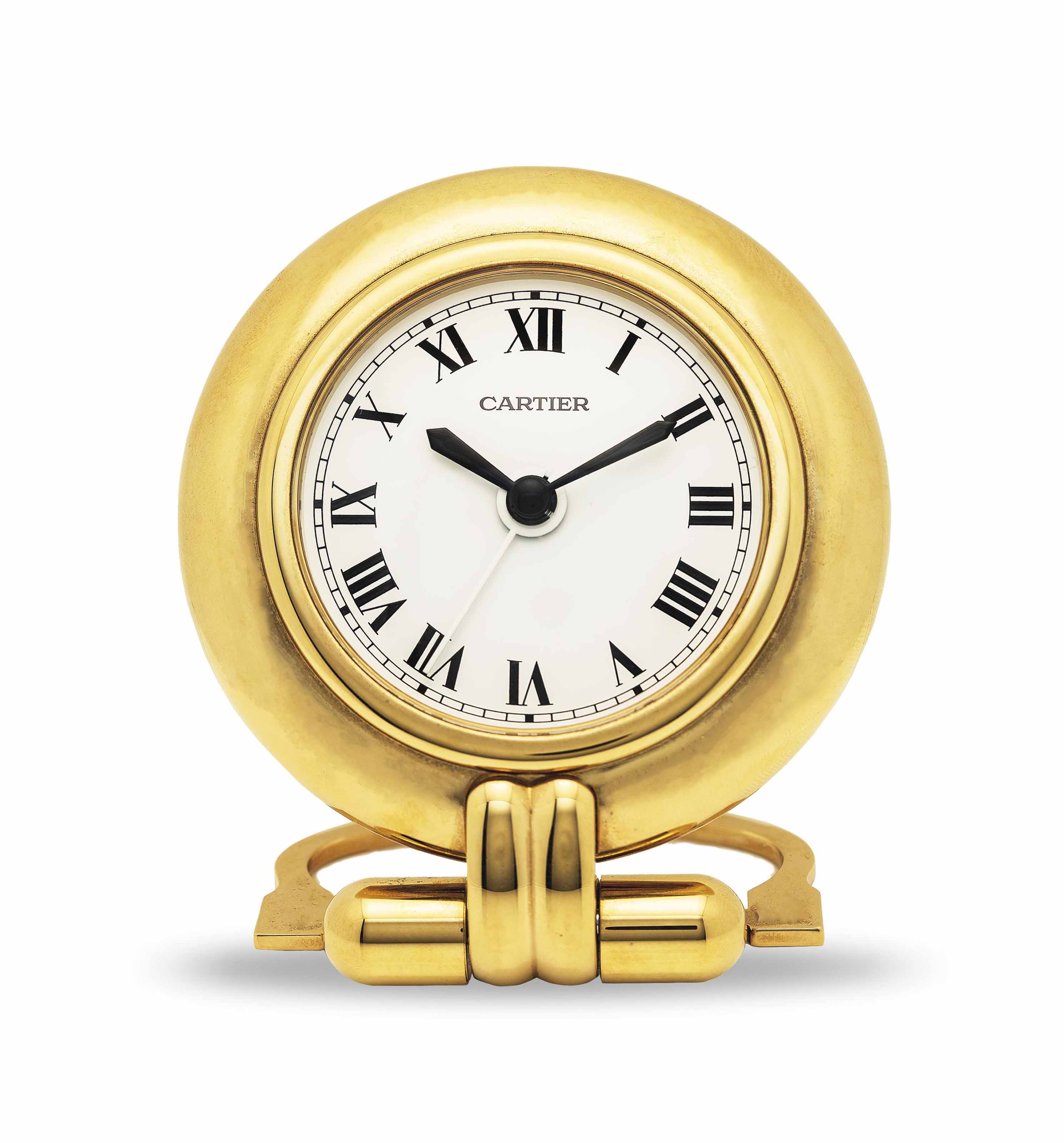 CARTIER. A GILT TRAVEL CLOCK WITH ALARM