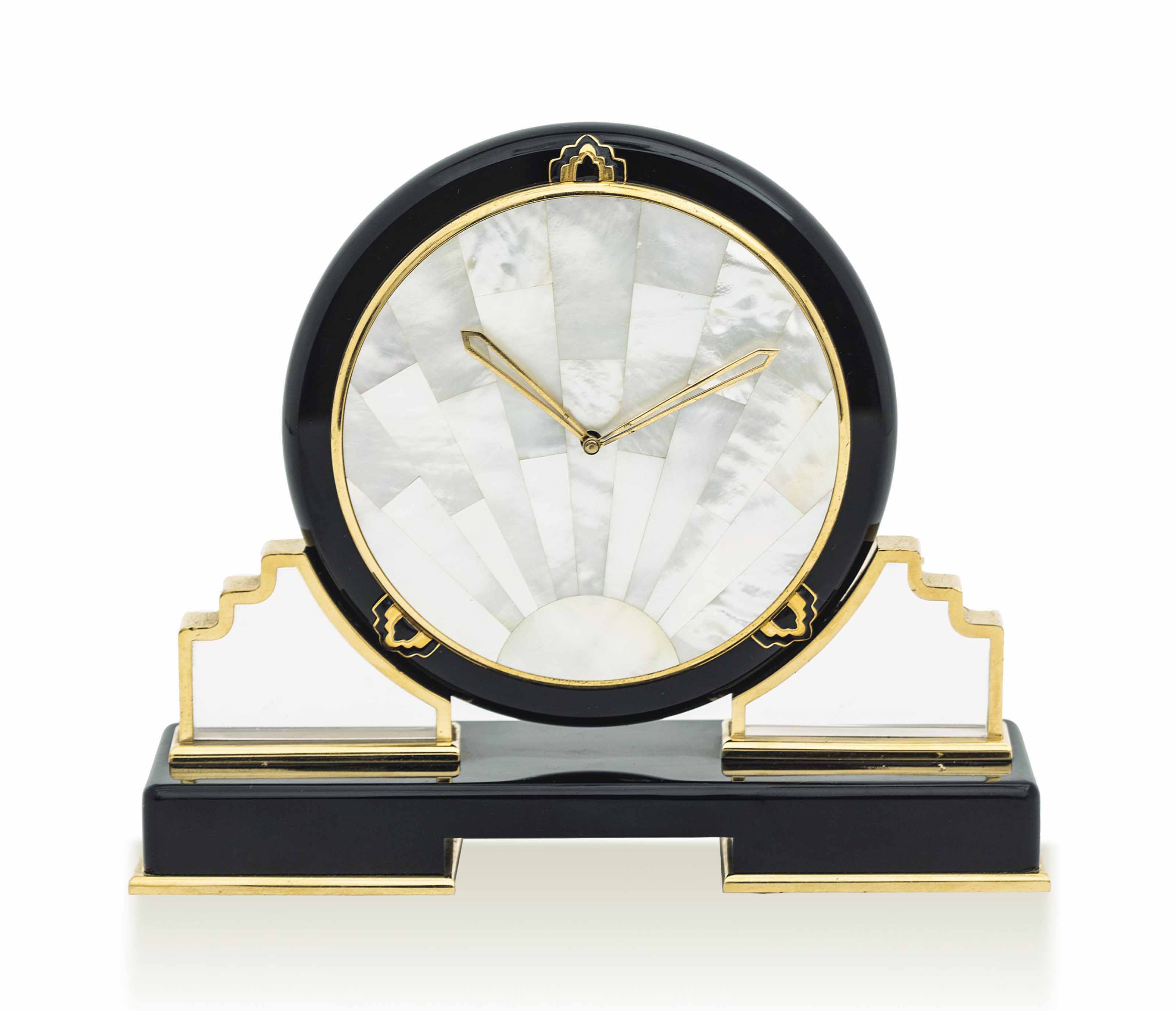 CARTIER. A VERY FINE ONYX AND MOTHEROFPEARL DESK CLOCK