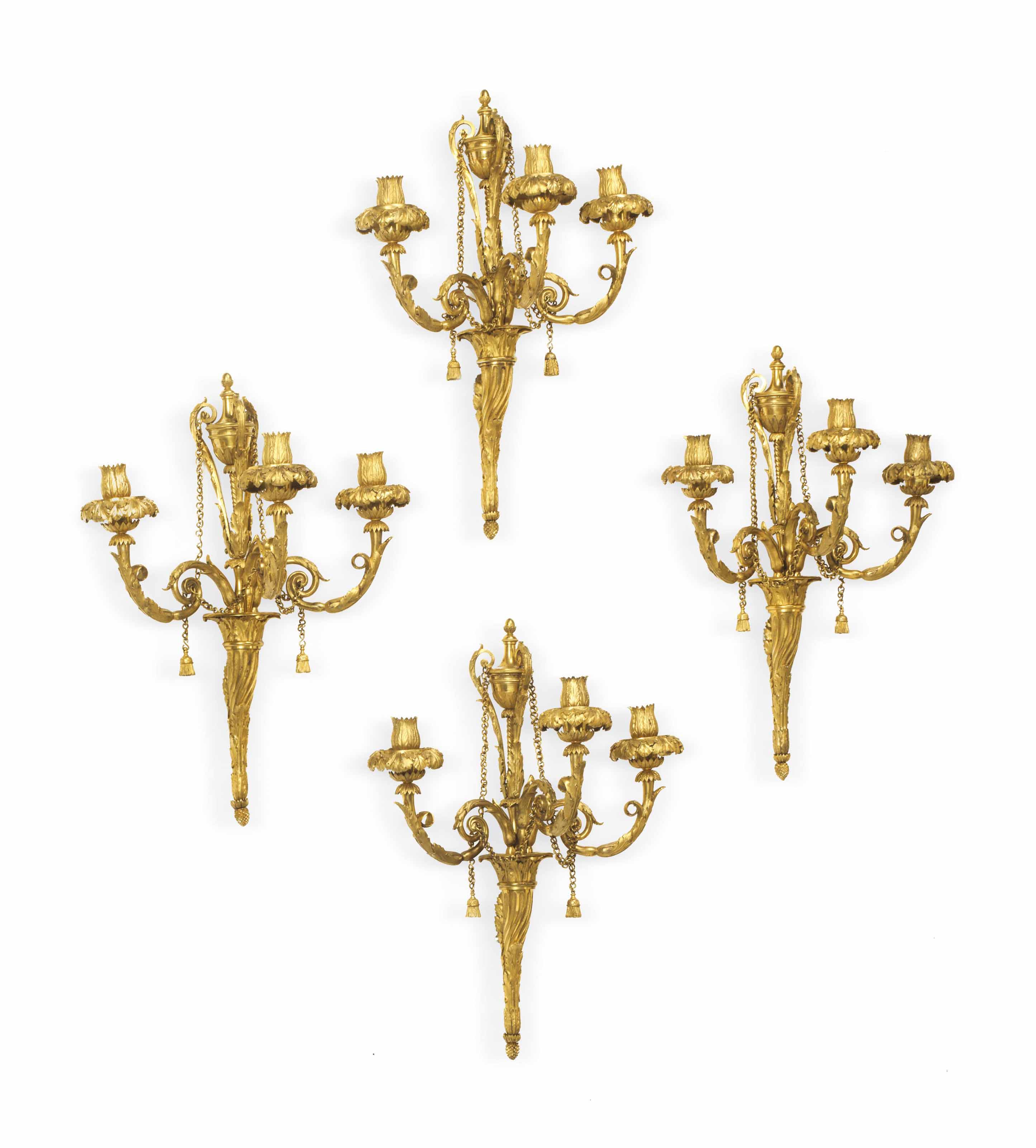 A SET OF FOUR LOUIS XVI ORMOLU THREE-BRANCH WALL-LIGHTS A SET OF FOUR LOUIS XVI ORMOLU THREE-BRANCH WALL-LIGHTS