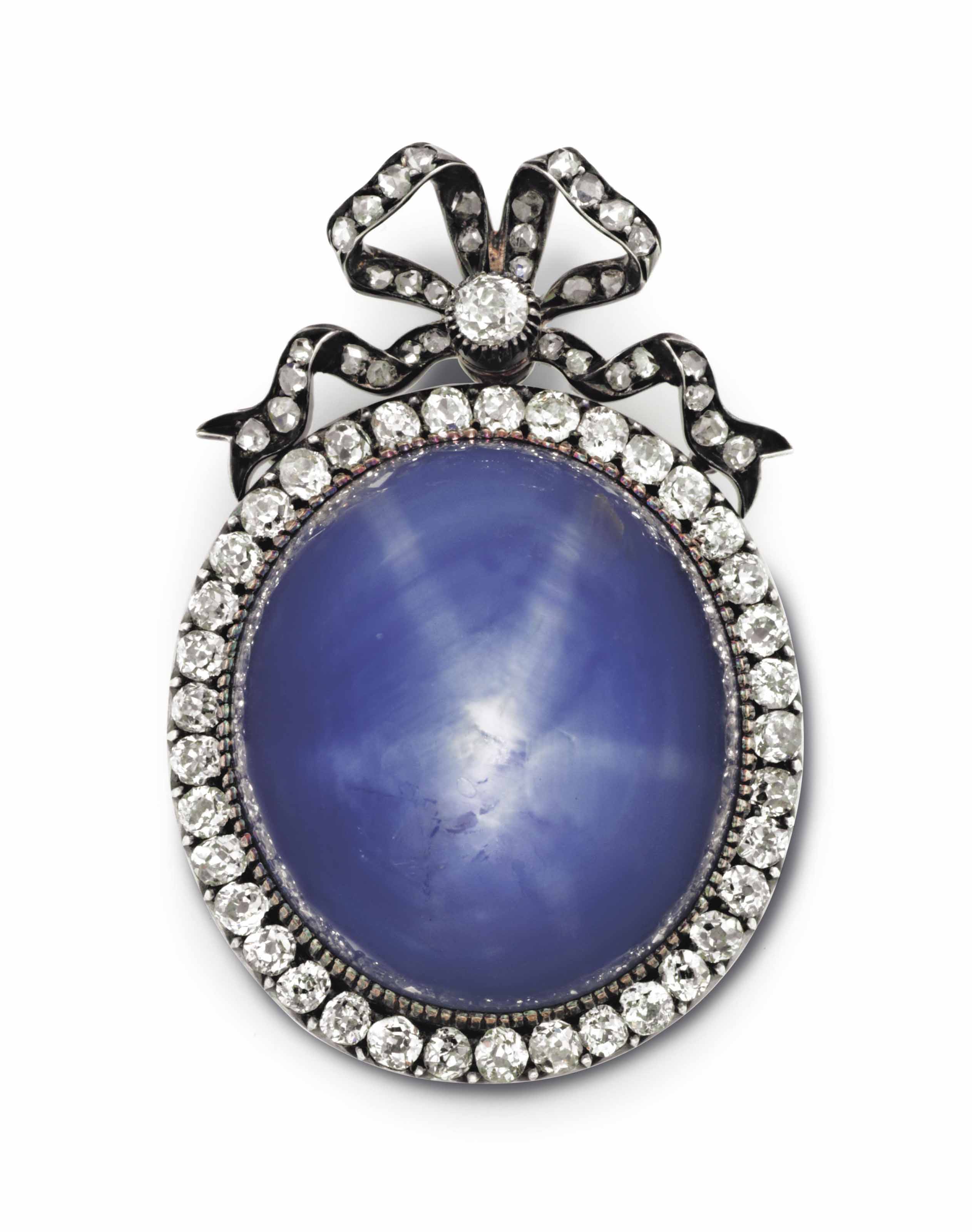A SILVER TOPPED GOLDMOUNTED STAR SAPPHIRE AND DIAMOND PENDANT BROOCH