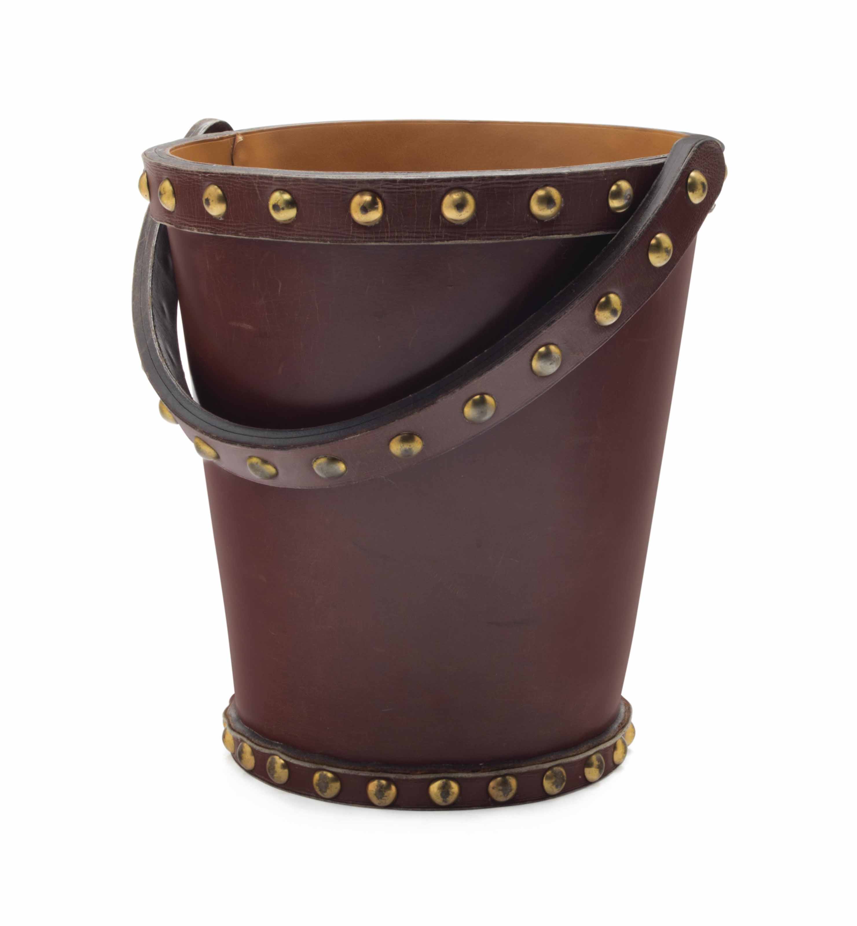 A FRENCH BRASS AND LEATHER WASTE PAPER BASKET , BY HERMÈS, CIRCA 1930