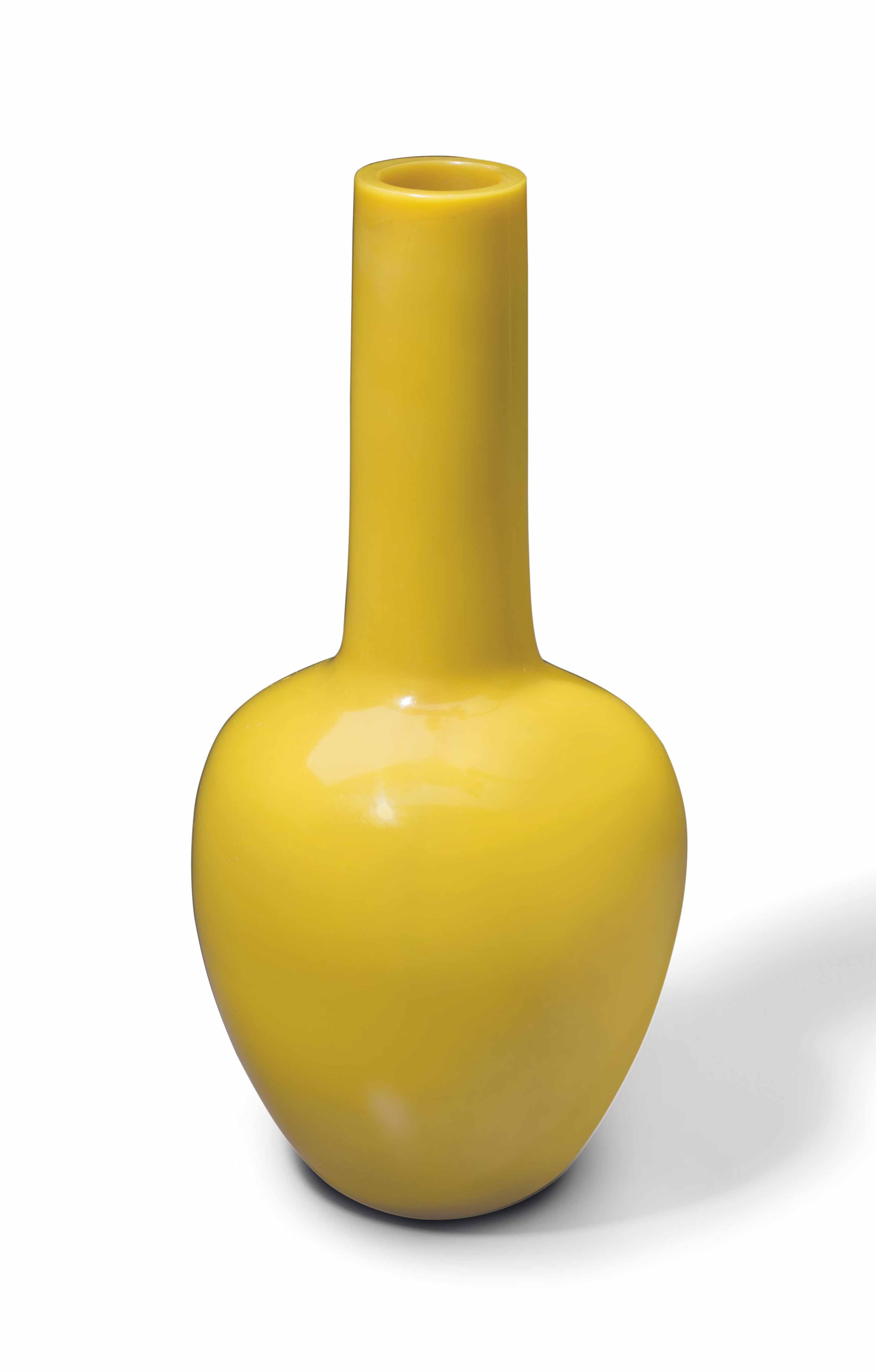 A YELLOW GLASS BOTTLE VASE