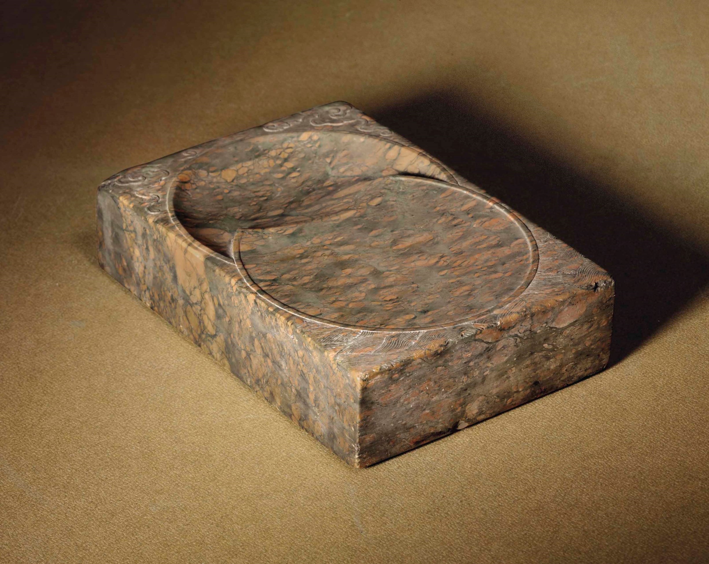 A RECTANGULAR PUDDINGSTONE INK STONE