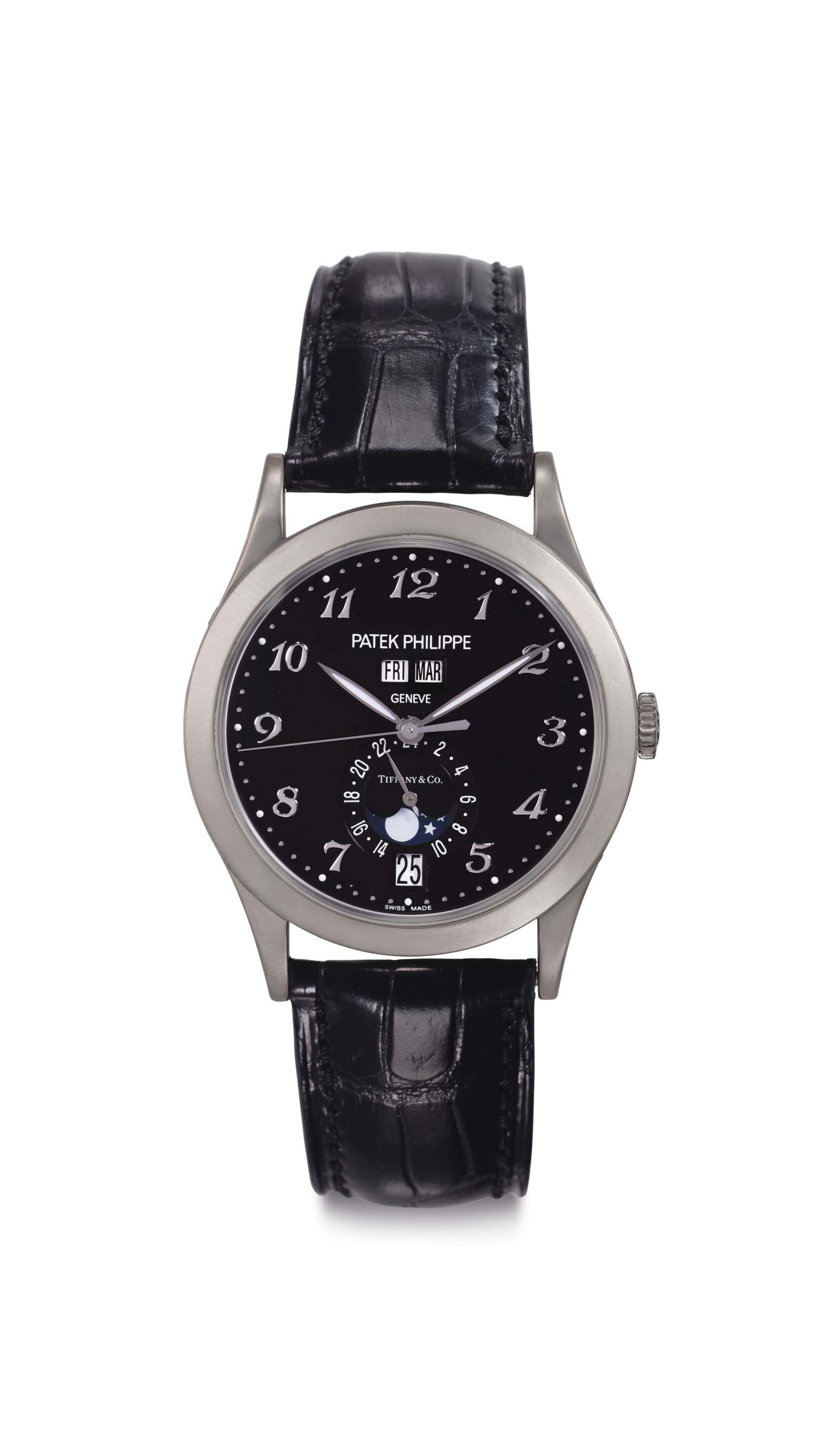 Patek Philippe. A Rare Limited Edition 18k White Gold Annual Calendar Wristwatch with Black Dial Upside Down Moon Phases Breguet Numerals and Center Seconds Signed Patek Philippe Geneve retailed by Ti...