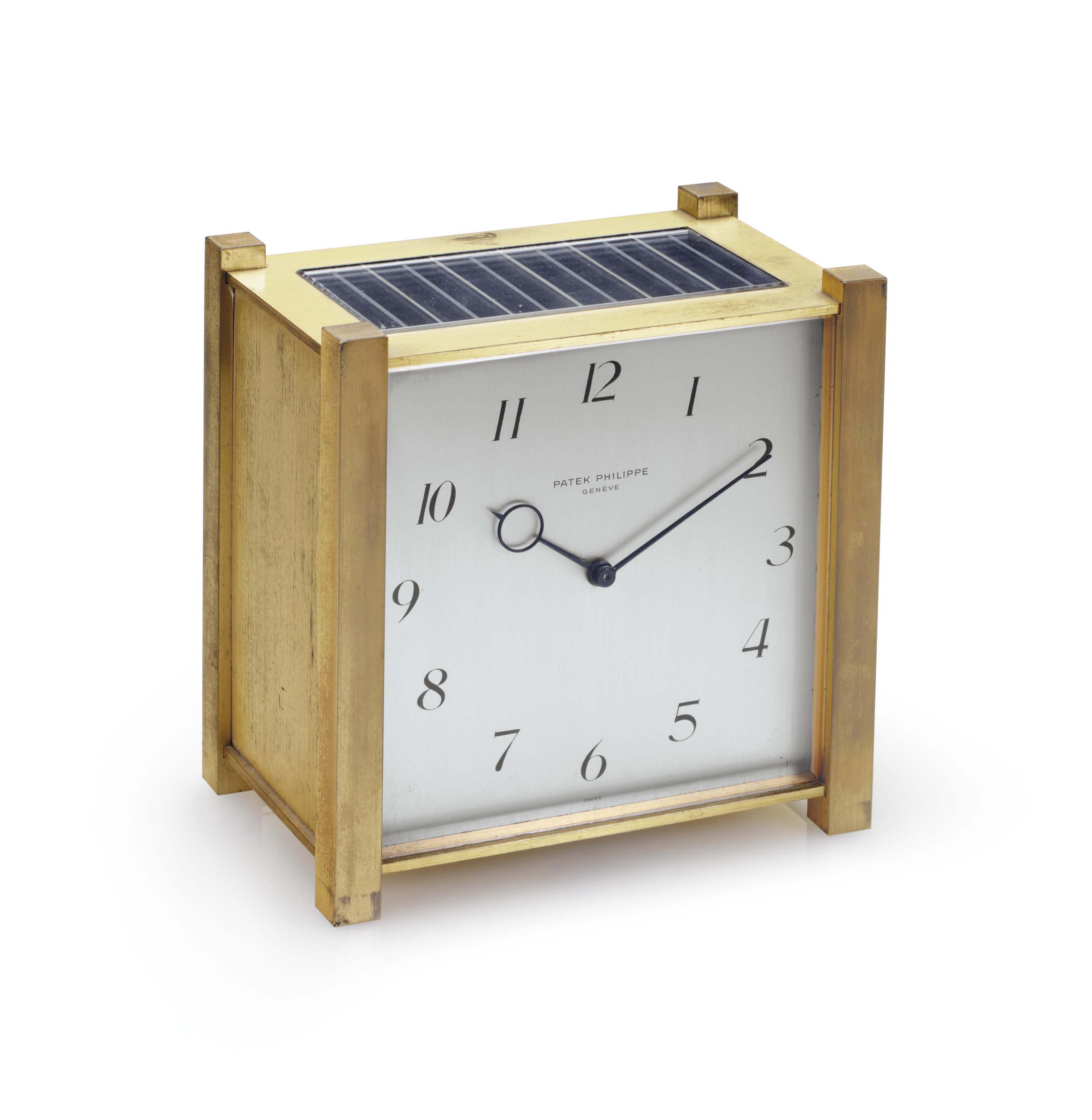 Patek Philippe. A Fine Gilt Brass SquareShaped Solar Powered Desk