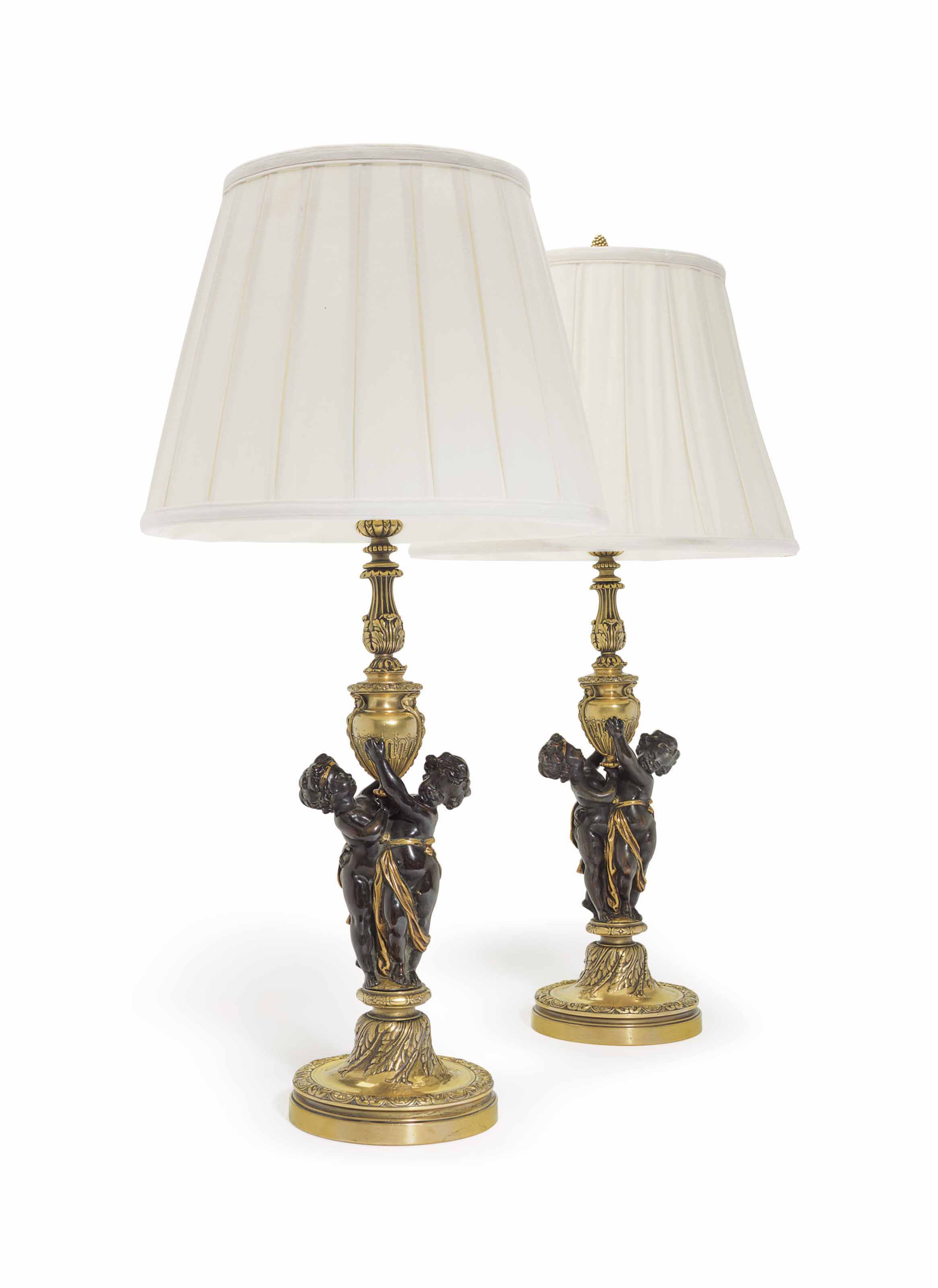 A PAIR OF AMERICAN GILT AND PATINATED BRONZE FIGURAL TABLE LAMPS , BY