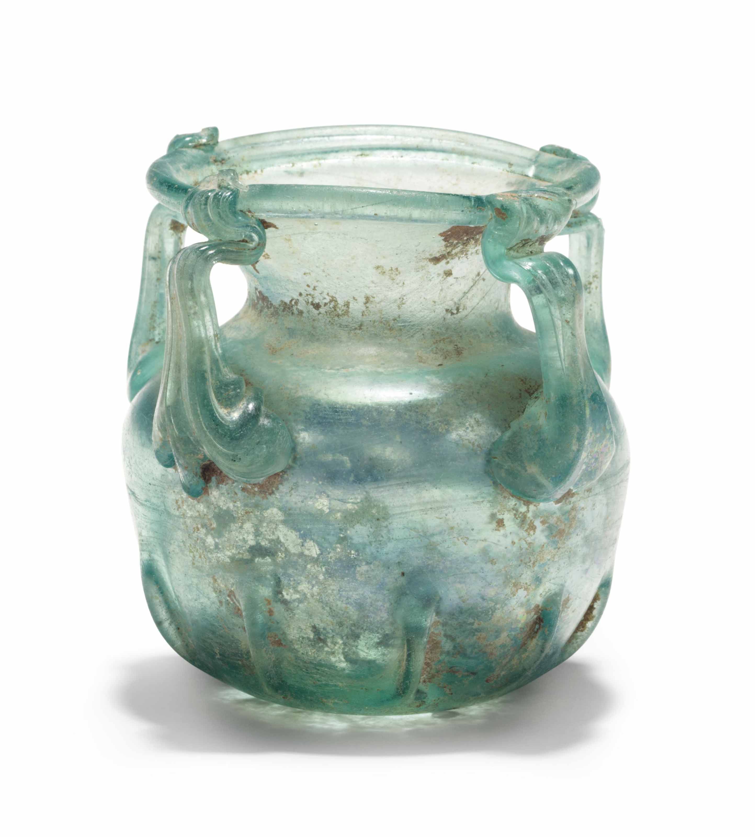 A LATE ROMAN GLASS FOURHANDLED JAR , CIRCA 4TH5TH CENTURY A.D