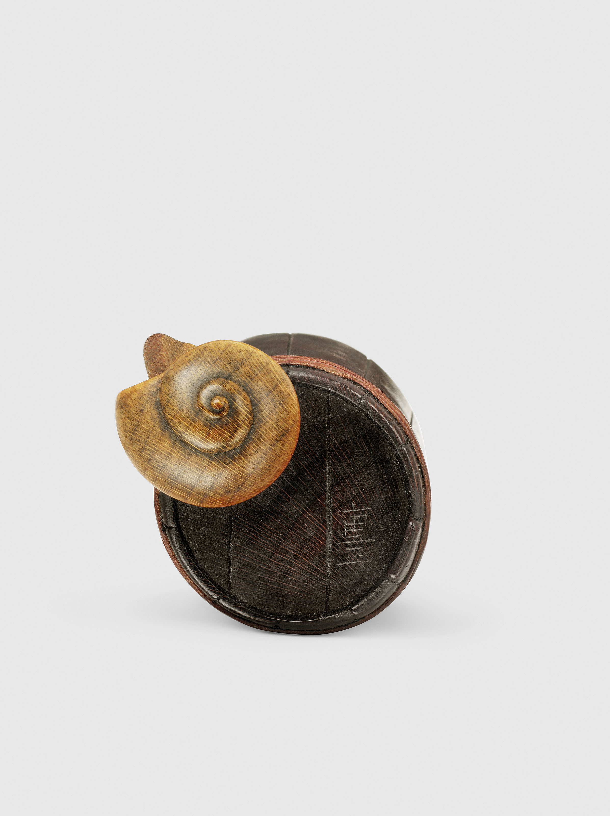 A WOOD NETSUKE OF A SNAIL ON A BUCKET , SIGNED SHIGEMASA , EDO PERIOD (19TH CENTURY) | Christie's