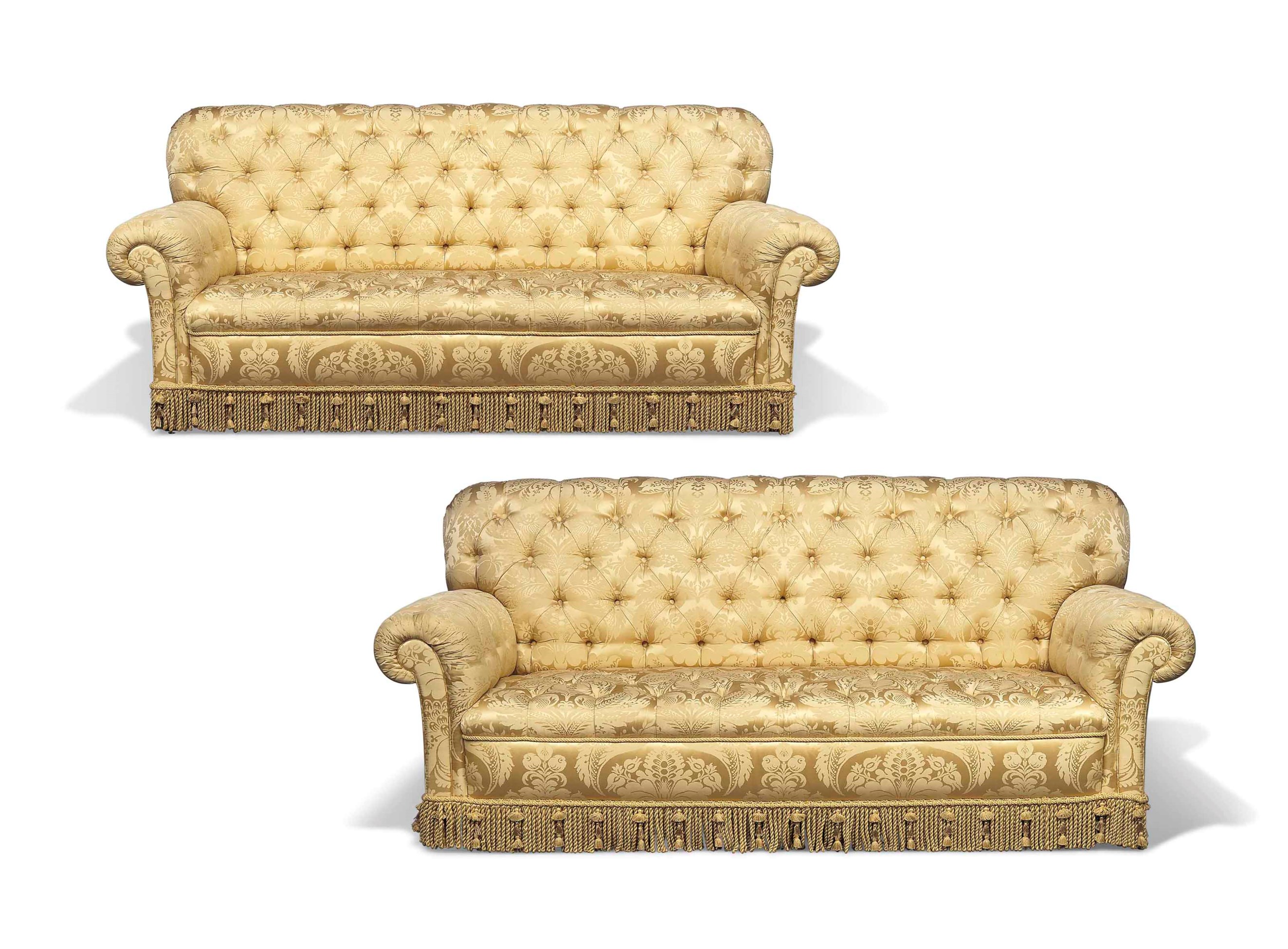A PAIR OF GOLD BUTTONED SILK DAMASK THREESEATER SOFAS