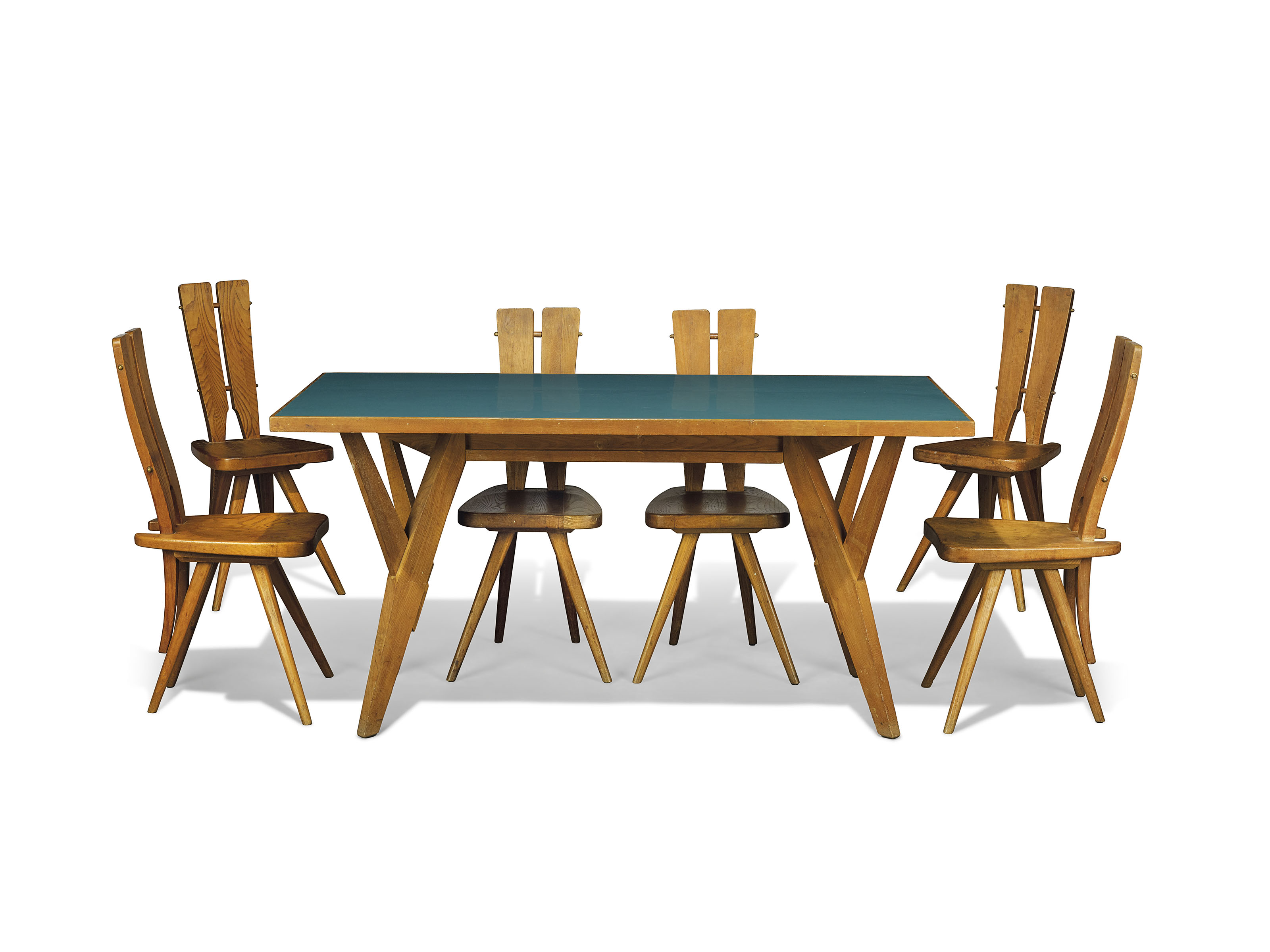 Carlo Mollino (1905-1973), a rare and important dining suite executed by Ettore Canali, Brescia, for the Casa del Sole, Cervinia. Comprising a table and six chairs, oak, chestnut, brass bolts, table with laminate-veneered surface table: 31⅛ high x 62&frac34; long x 31&frac34; in wide (79 x 159.5 x 79.5 cm). Chairs: each 36&frac12; in (93 cm.) high. Designed in 1953, this suite was executed circa 1954-1955. Sold for &pound;668,750 on 3 October 2017 at Christie's in London