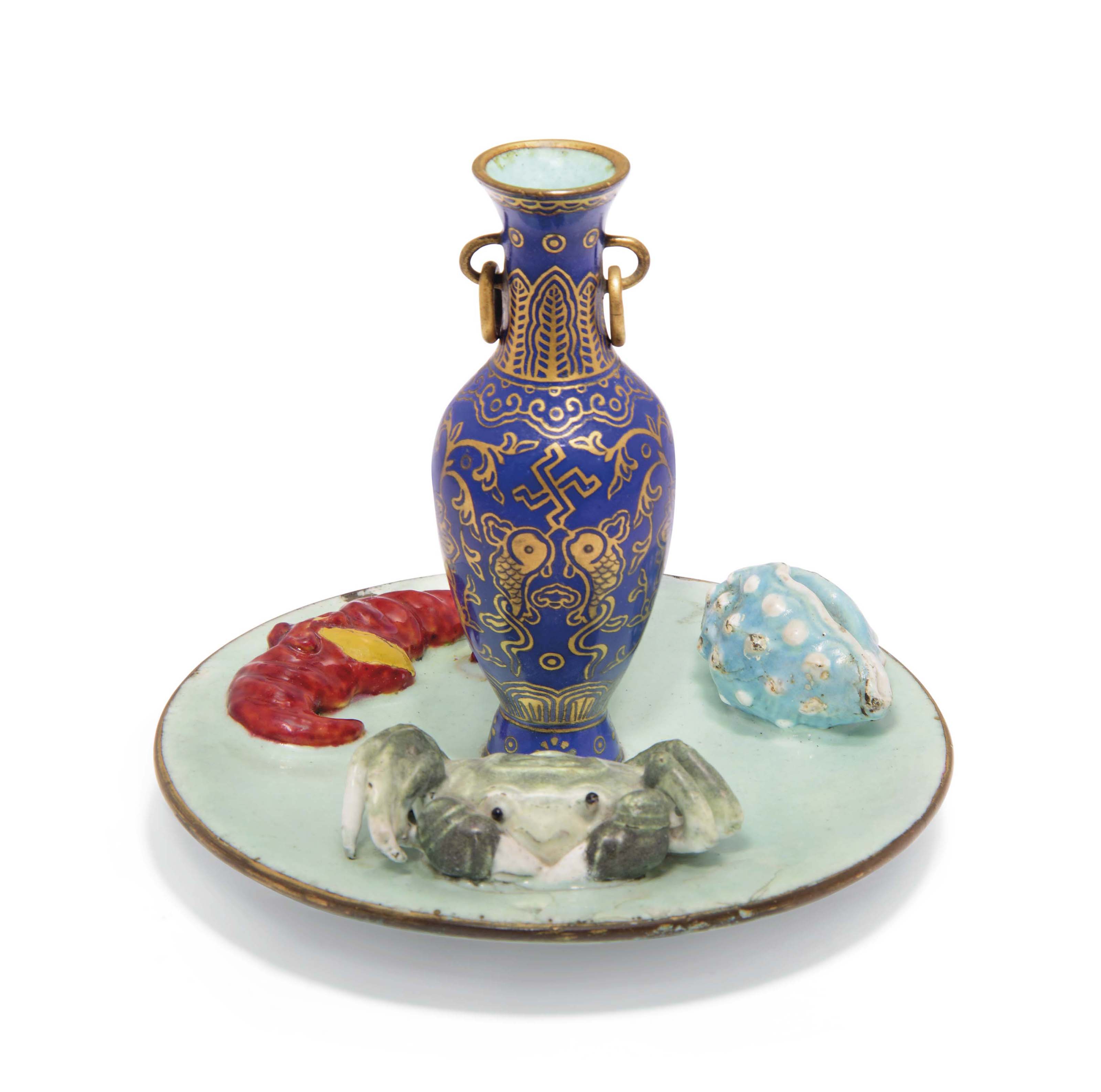 A PAINTED ENAMEL AND GILTDECORATED SAUCER