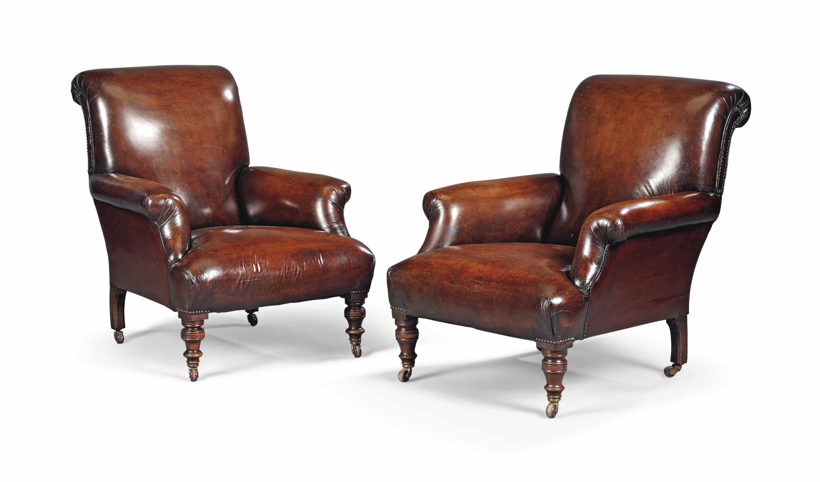 A PAIR OF ENGLISH LEATHERUPHOLSTERED ARMCHAIRS , IN THE MANNER OF