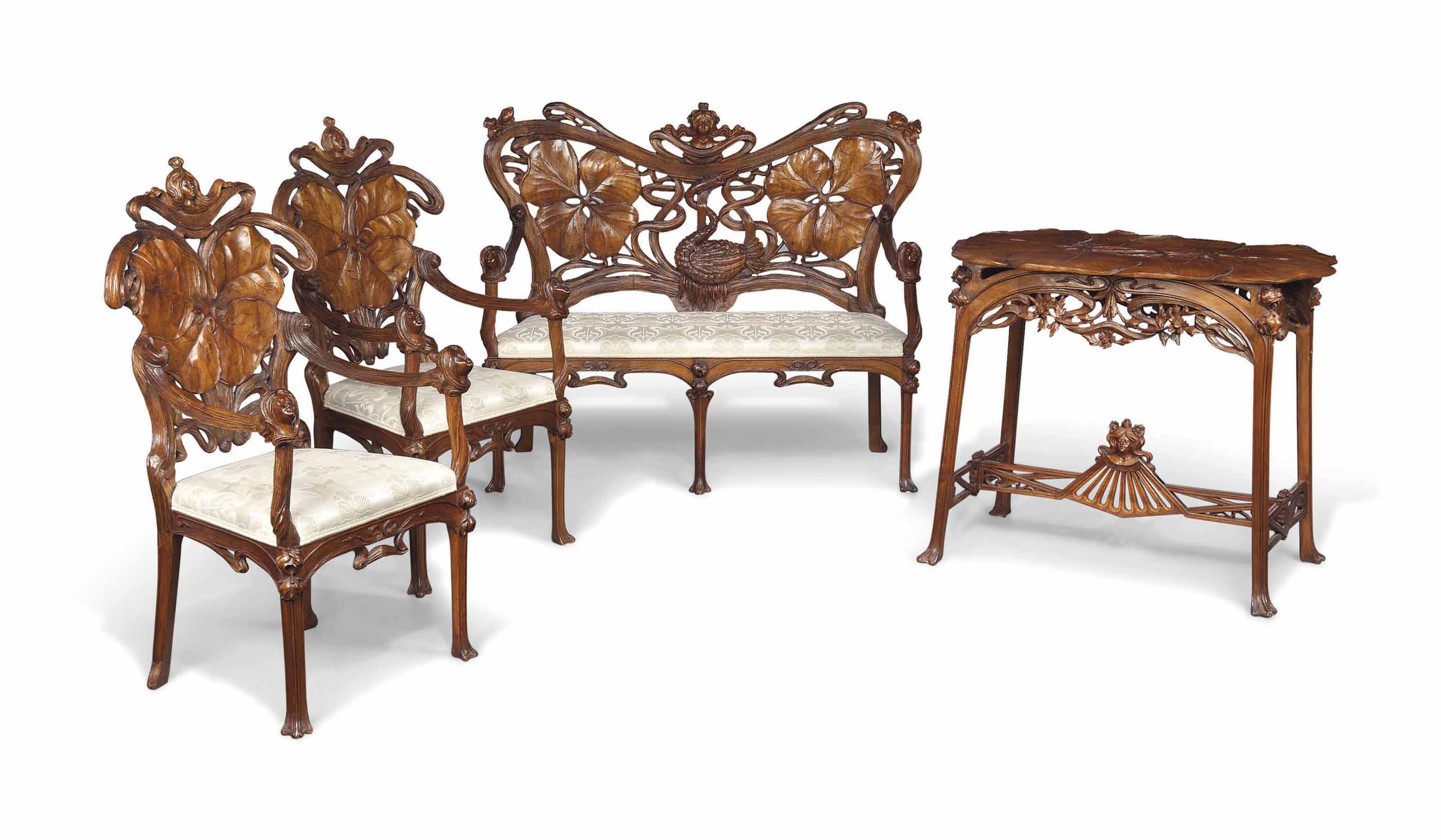 AN ITALIAN ART NOUVEAU CARVED WALNUT AND UPHOLSTERED FIVEPIECE SALON SUITE
