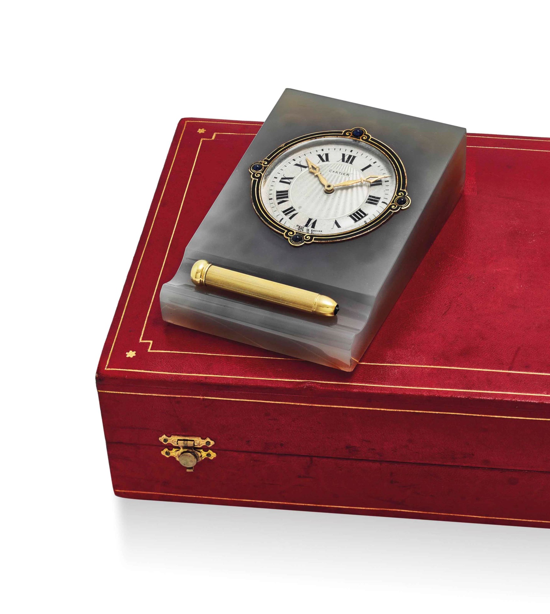 CARTIER. A FINE AND ELEGANT AGATE, ENAMEL AND SAPPHIRESET DESK CLOCK WITH 18K GOLD LEAD PENCIL