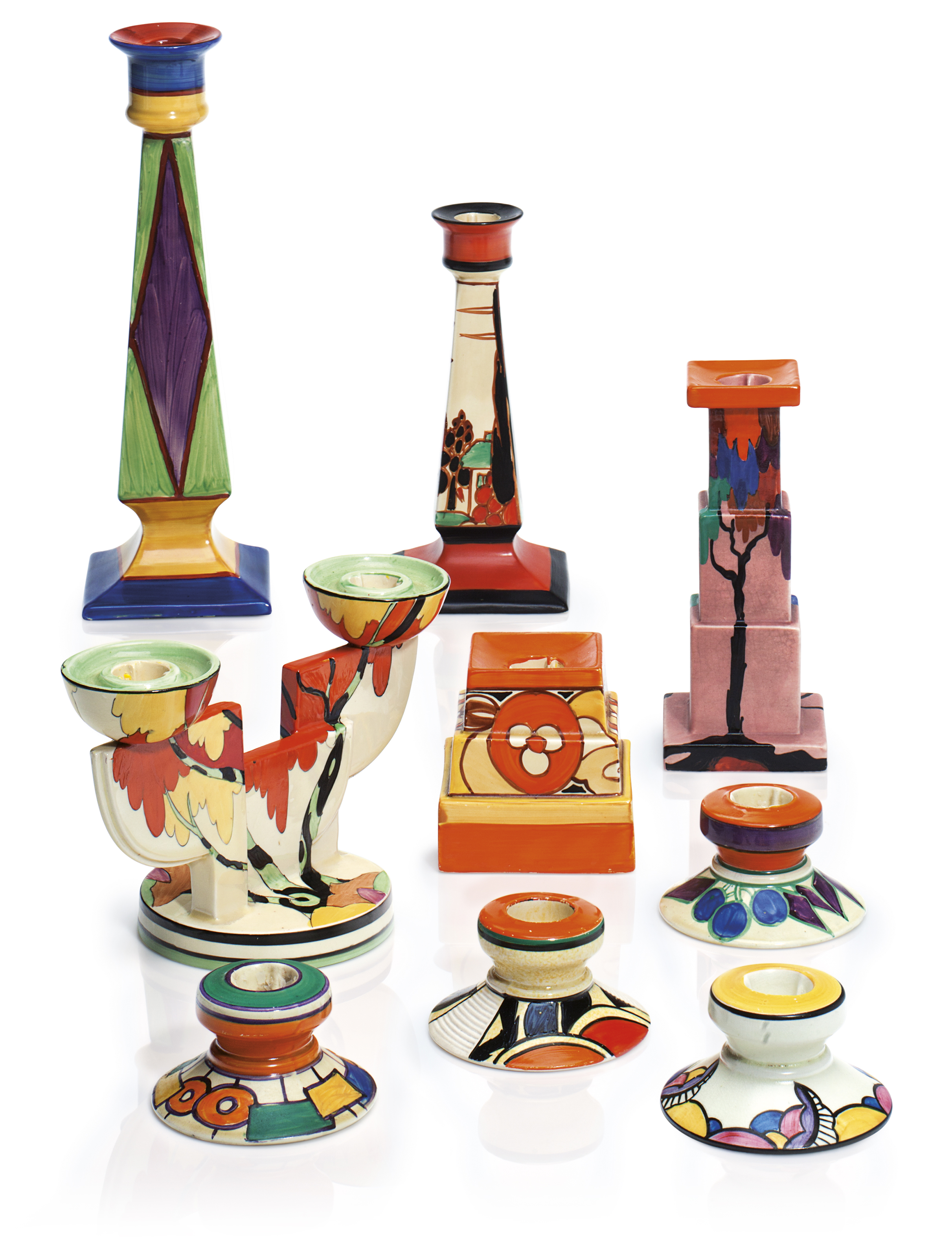 A GROUP OF NINE CLARICE CLIFF CANDLESTICKS, SECOND QUARTER 20TH